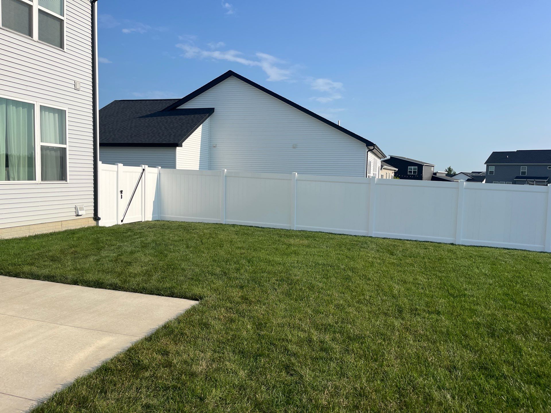 White Vinyl Privacy Fence Installation With Double Gates in Waterloo by Perfect Picket Fence and Stain