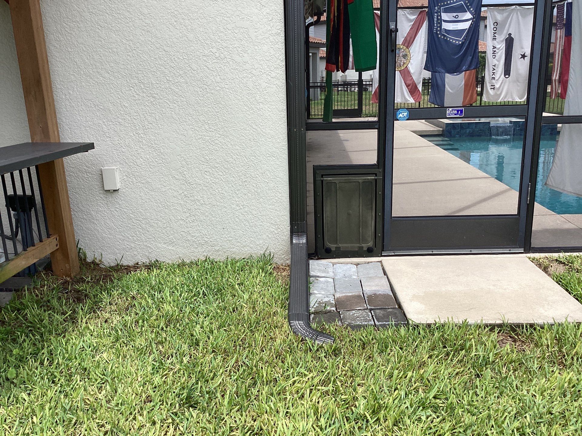 Musket brown seamless gutters with splash guards, new downspouts, and extensions in Bradenton, FL by Gutter Professors