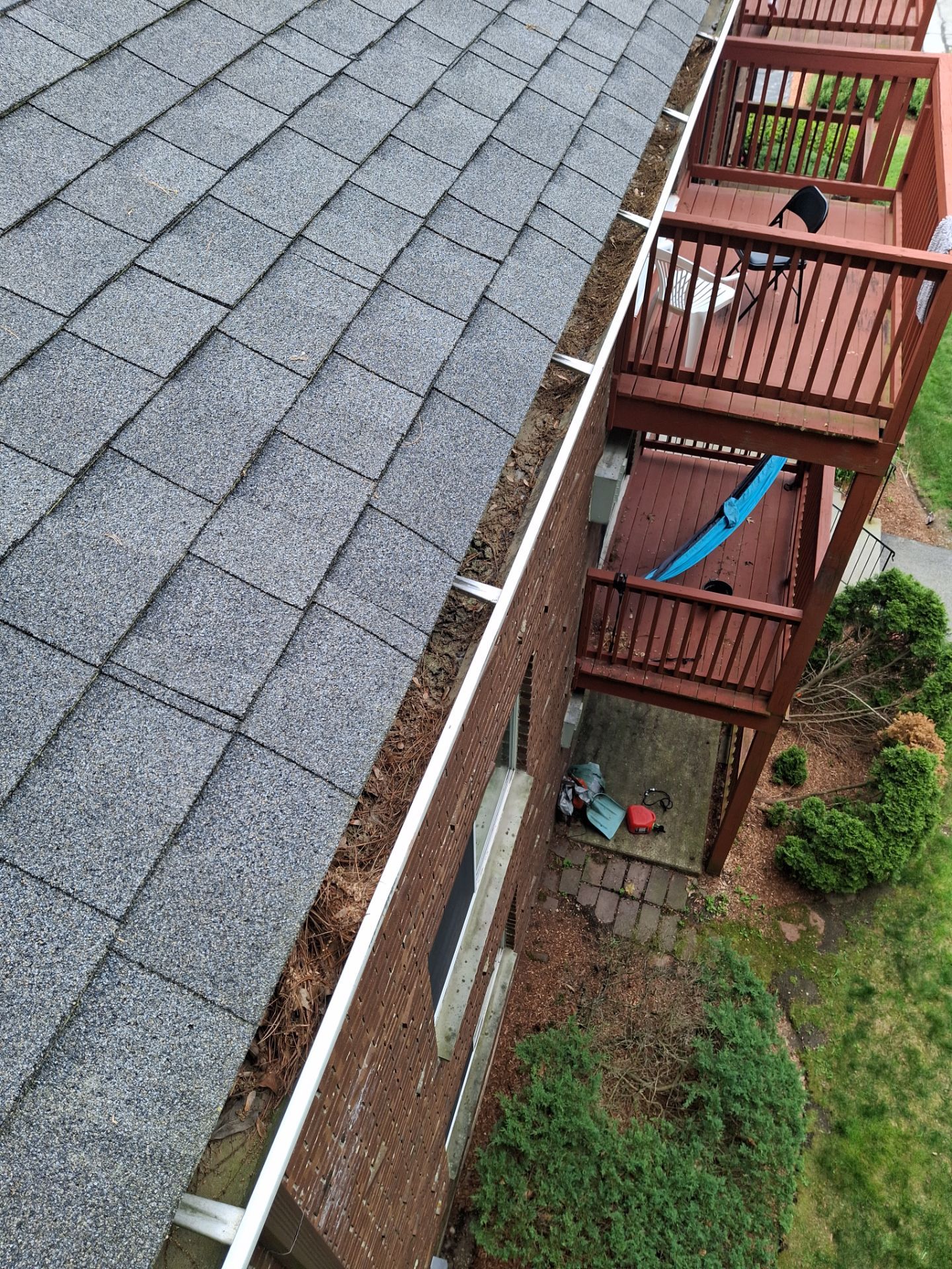 Commercial gutter cleaning Manchester, NH before photo with filled gutters