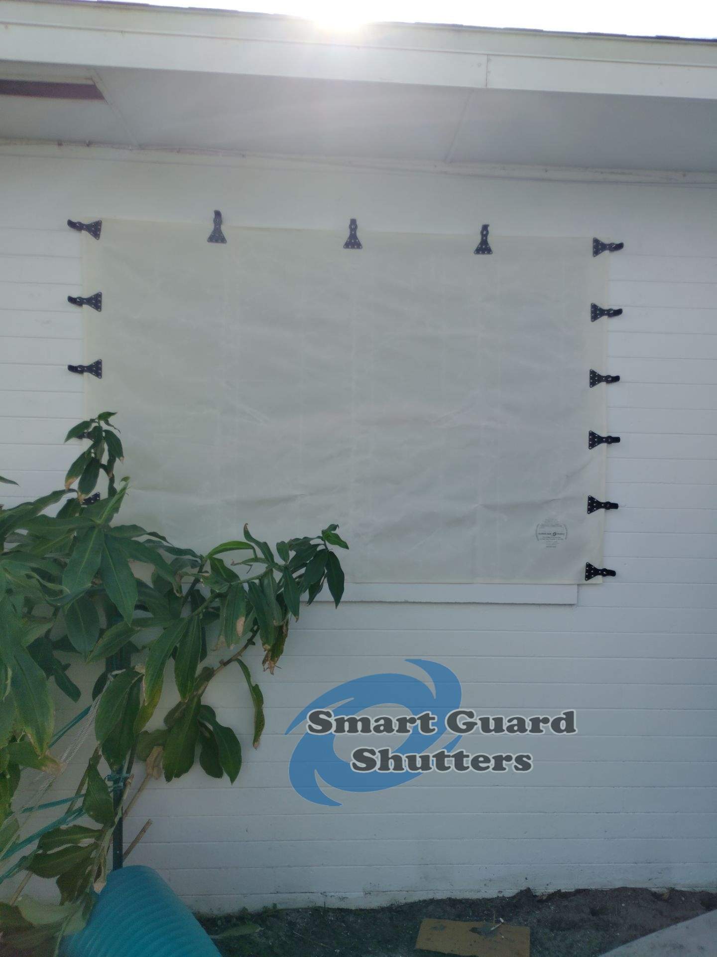 Hurricane Fabric in White / Decorative Bahama in Pastel Turquoise by Smart Guard Shutters