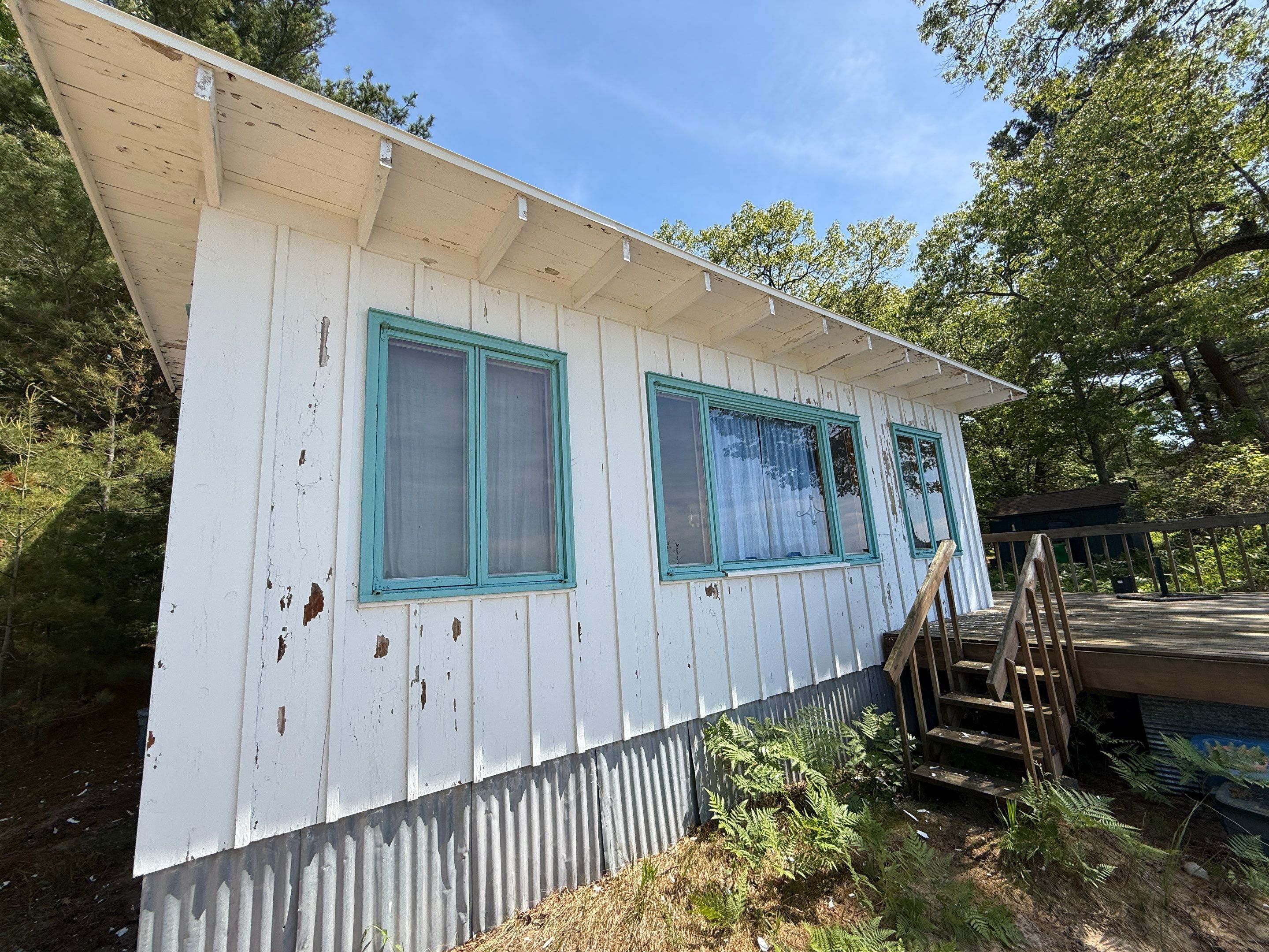 Lakeside Cottage Exterior Painting and Teal Trim Restoration in Mears by Gordon Painting