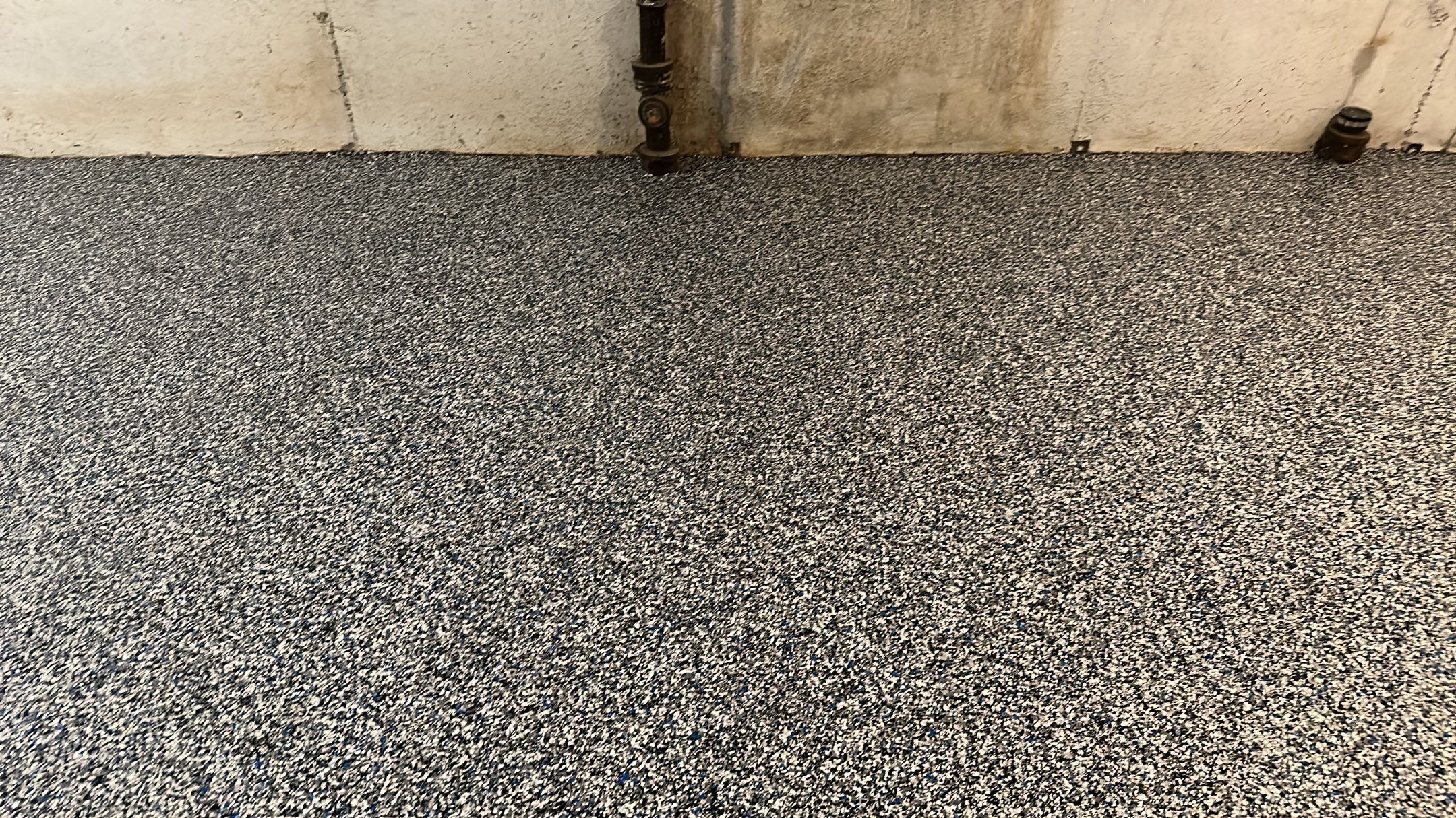 A beautiful Banner Garage Coating in a basement  by Banner Garage