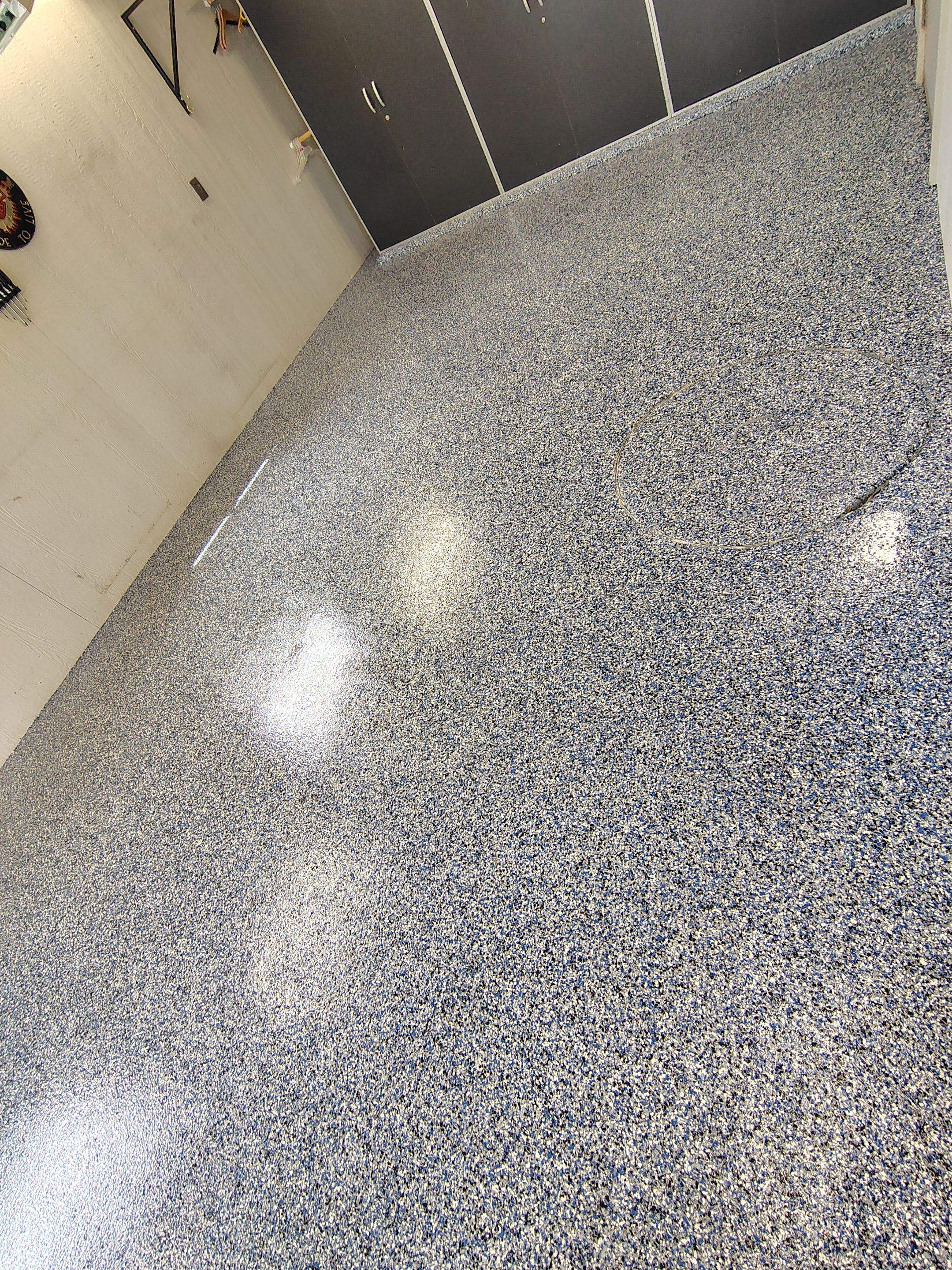 Custom Grey Flake Epoxy Garage Floor Installation in Remsen by Select Painting, Coatings & Garage Cabinets