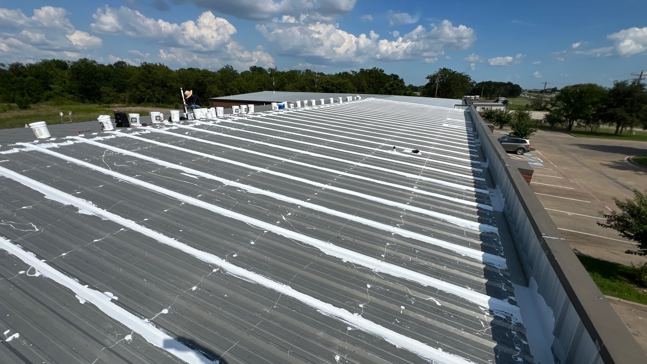 Commercial Roofing Installation using TRP #924 Eterna-Sil Premium Silicone Roof Coating by Harvey Roofing & Construction