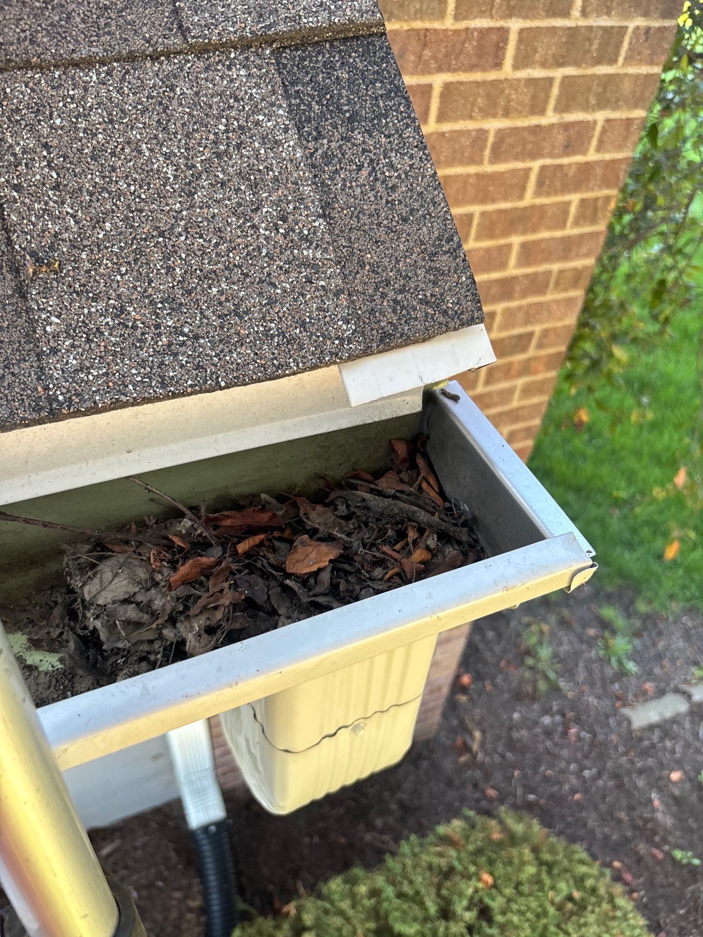 Commercial gutter cleaning Iowa City, IA before photo with filled gutters