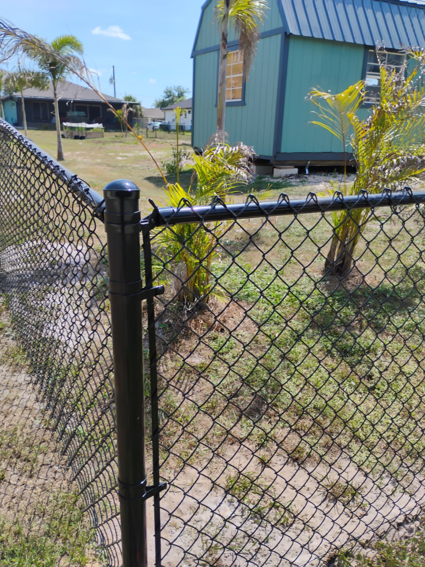 Black Vinyl-Coated Chain Link Fence and Rolling Gate Installation in North Port by True Fence LLC