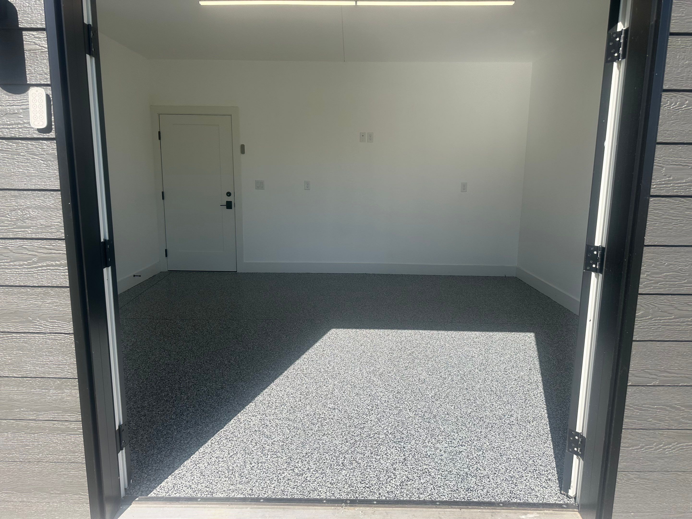 Multi-Color Epoxy Flake Garage Floor Installation in Sioux Falls by Select Painting, Coatings & Garage Cabinets