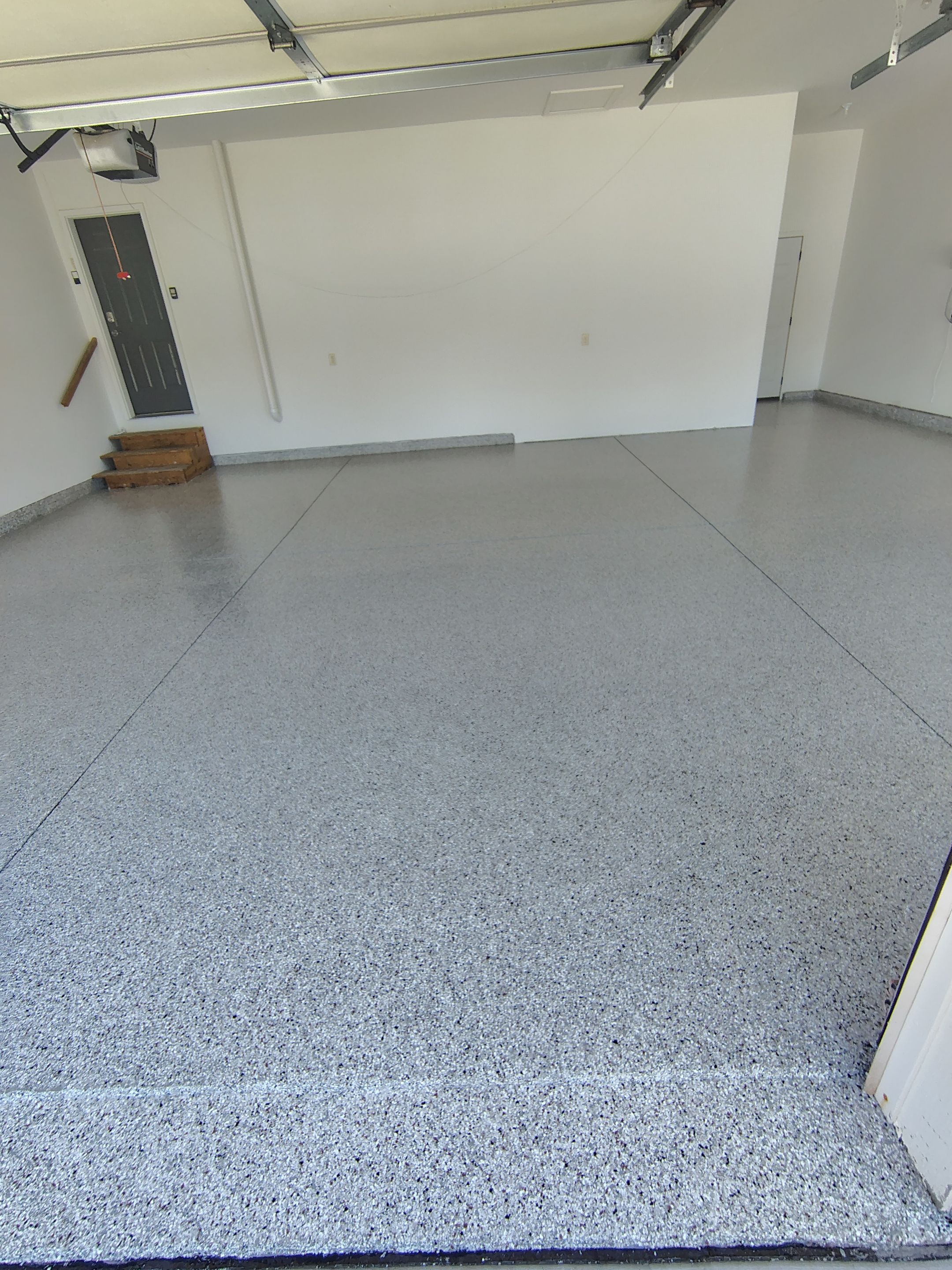 Custom Grey Speckled Epoxy Floor Coating for Sioux Falls Garage by Select Painting, Coatings & Garage Cabinets