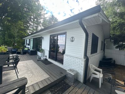 Black Gutter and Gutter Helmet Installation for Suttons Bay Home