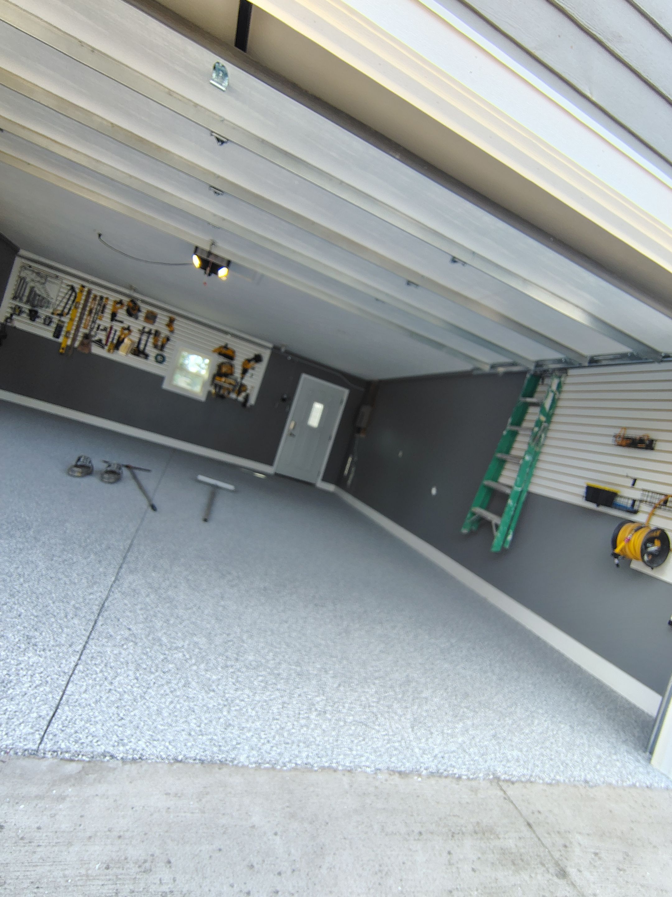 Custom Garage Floor Coating and Backyard Patio Refinishing in Tyndall by Select Painting, Coatings & Garage Cabinets