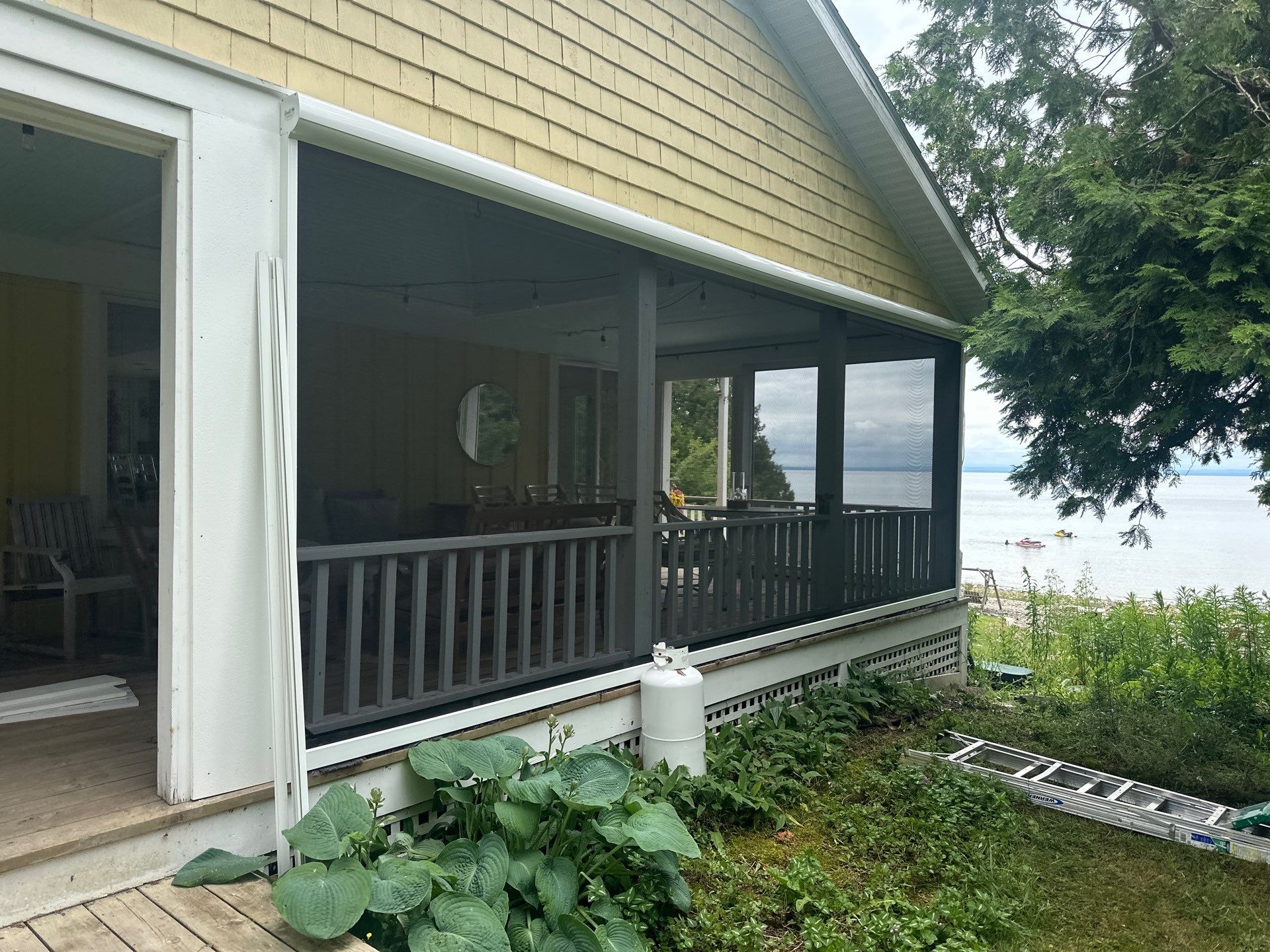Sunesta motorized Sentry Privacy Screen Installation for Saint Ignace Waterfront Porch by Rainbow Seamless Systems