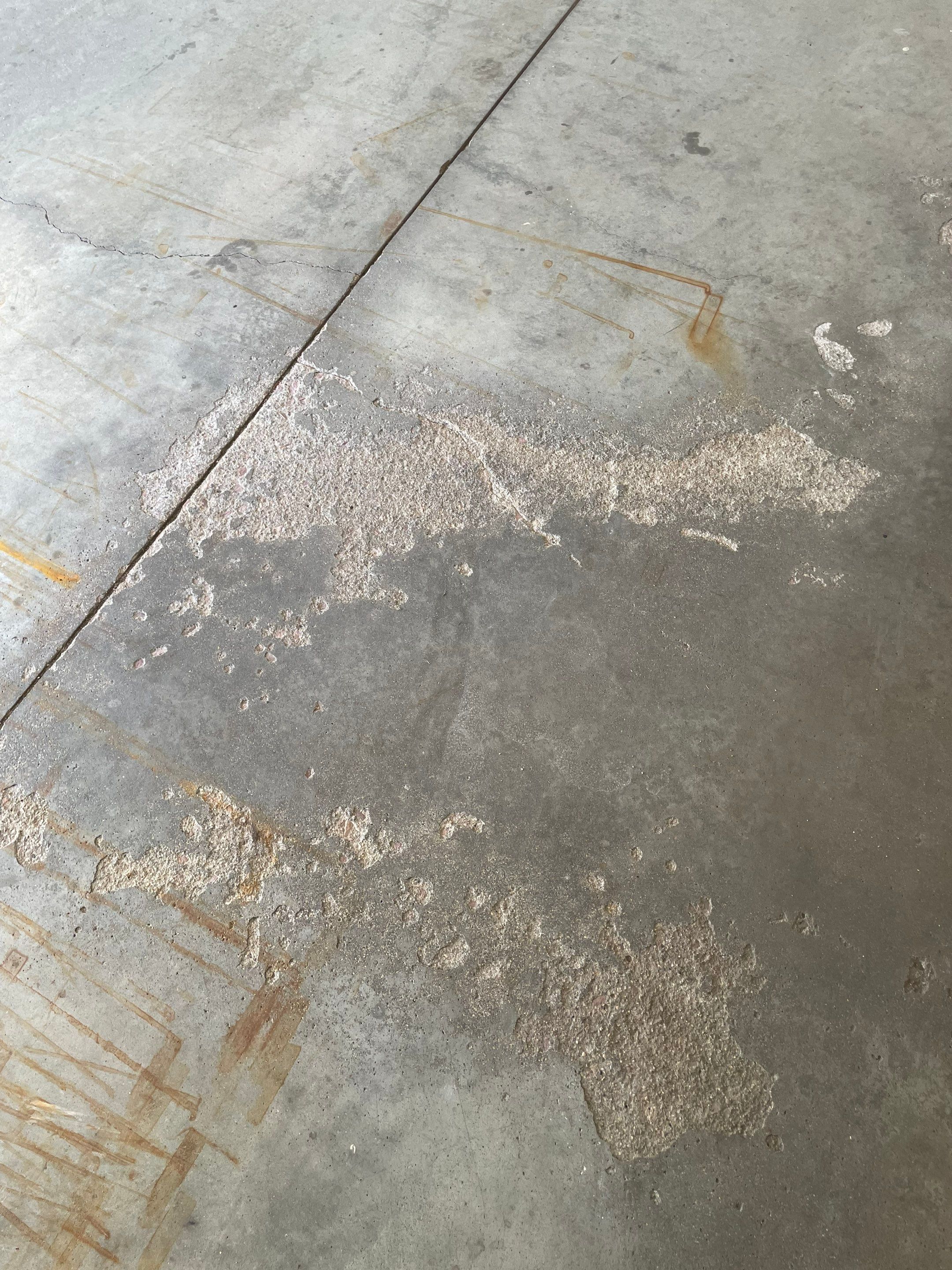 Yankton Garage Floor Restoration with Gray Speckled Epoxy Coating by Select Painting, Coatings & Garage Cabinets