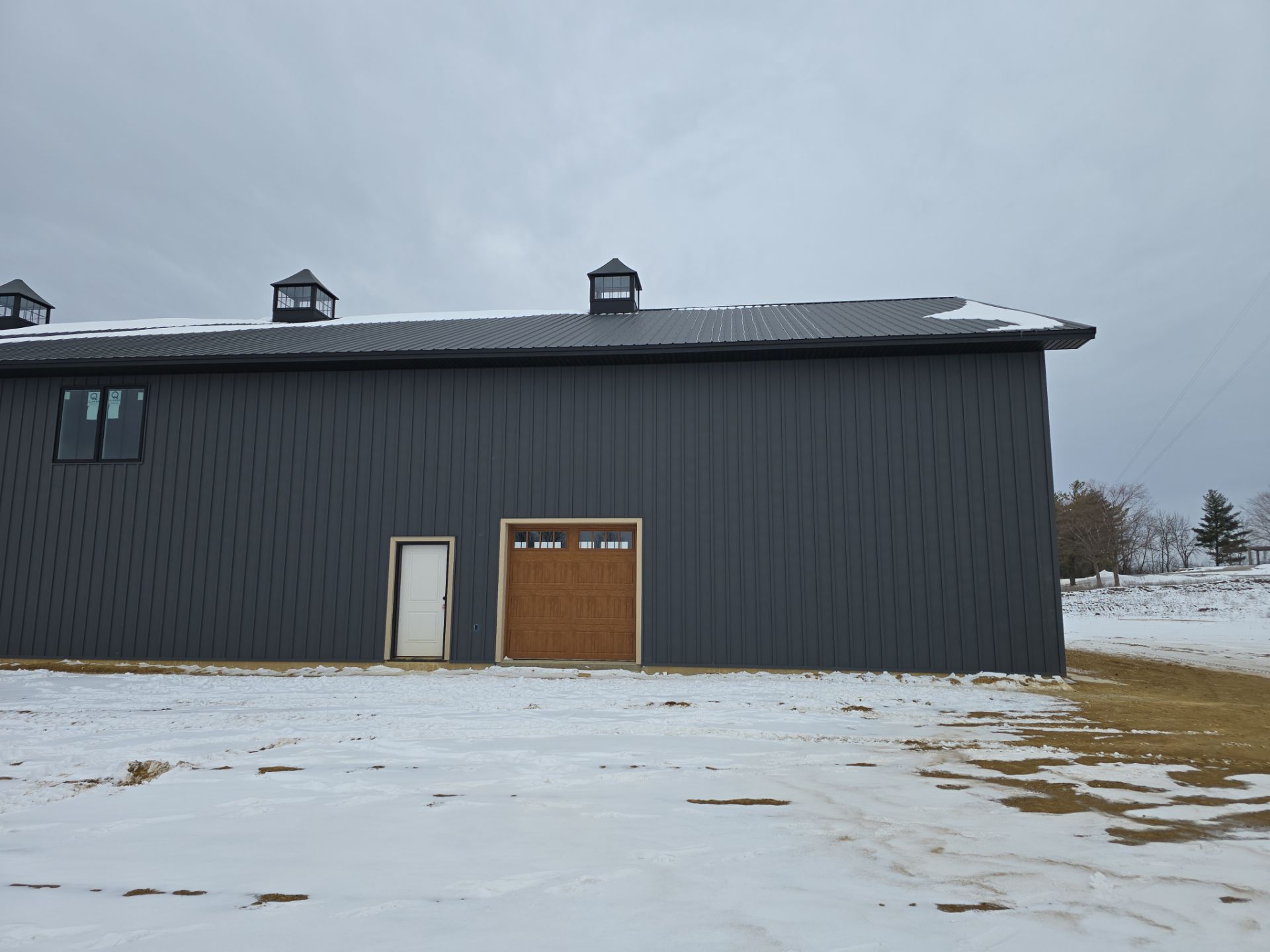 New Home construction w/ board and batten sides and metal roof  by Miles Construction 