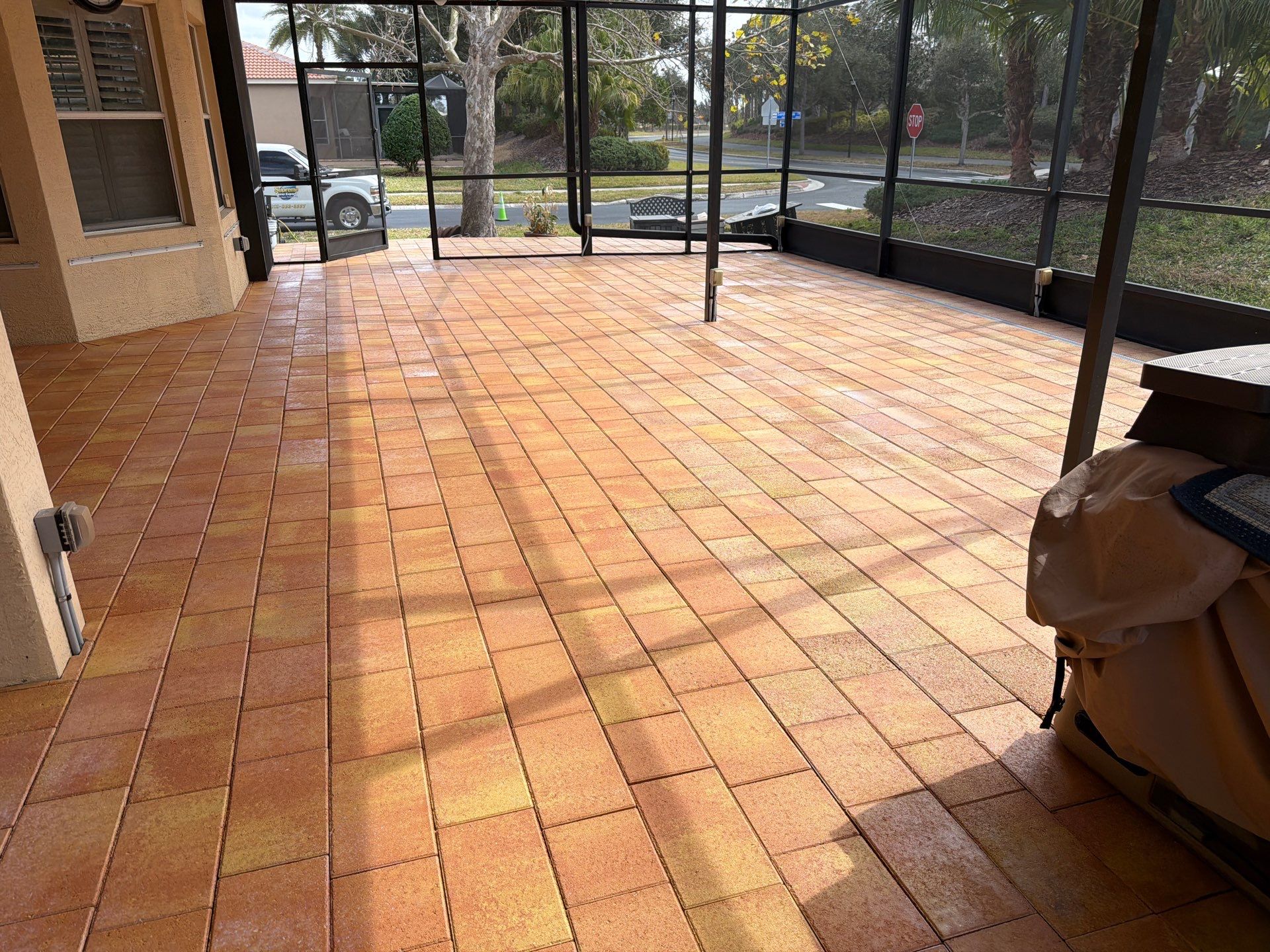 Paver Sealing for Herringbone Driveway and Screened Lanai in Valencia Lakes by Supreme Paver Experts