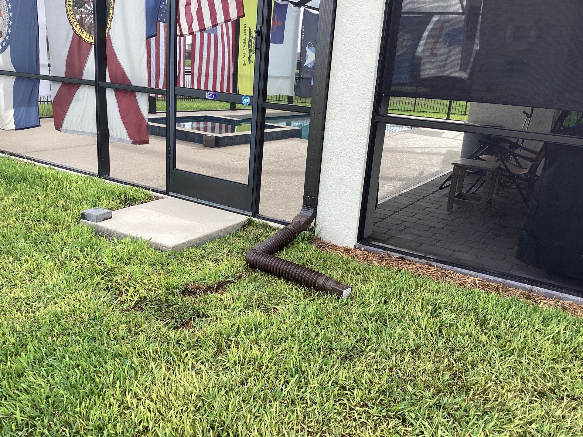 Musket brown seamless gutters with splash guards, new downspouts, and extensions in Bradenton, FL by Gutter Professors