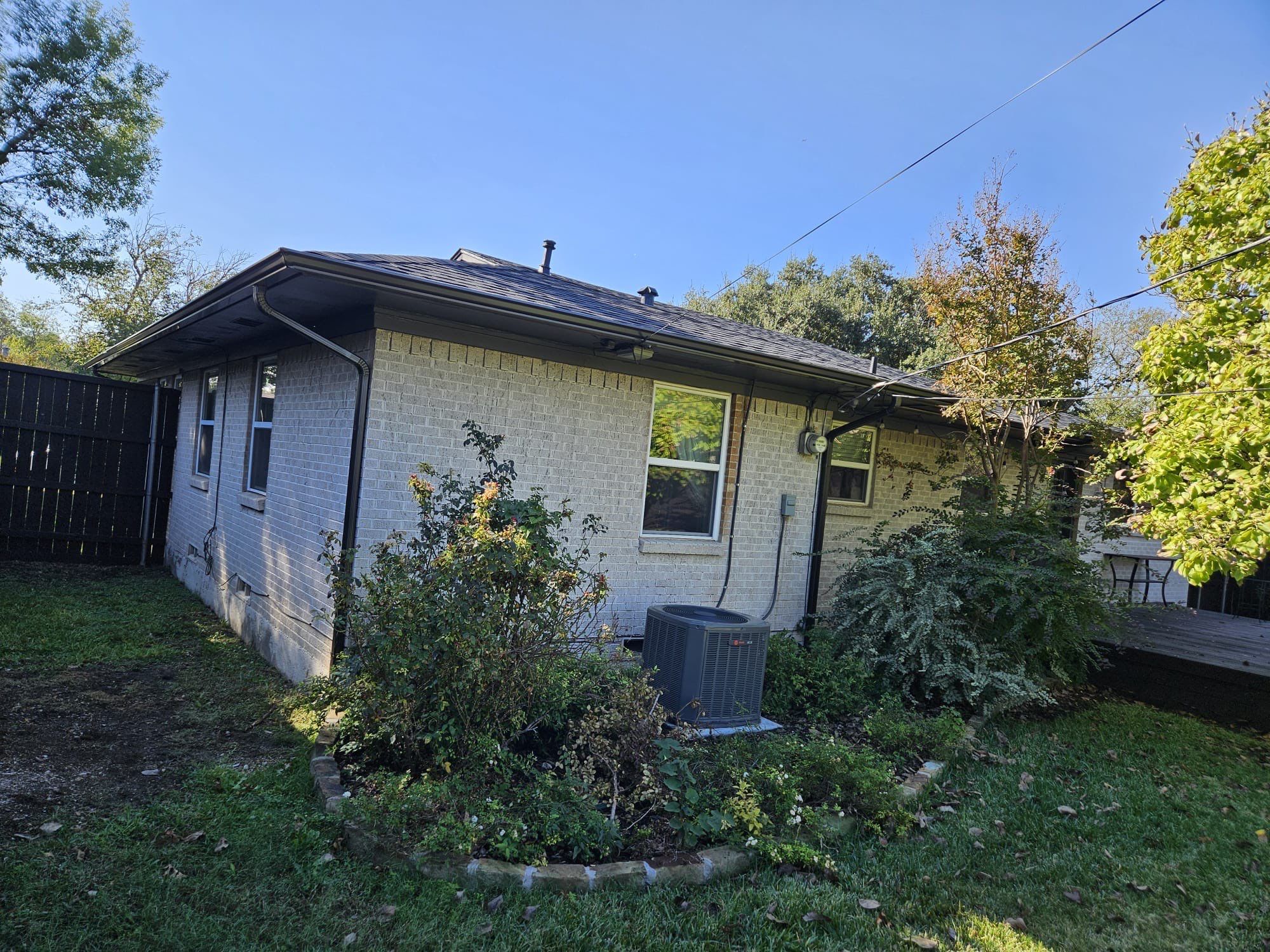 White brick/black accents with IKO Granite Black by Tejas Roofworks + Restoration
