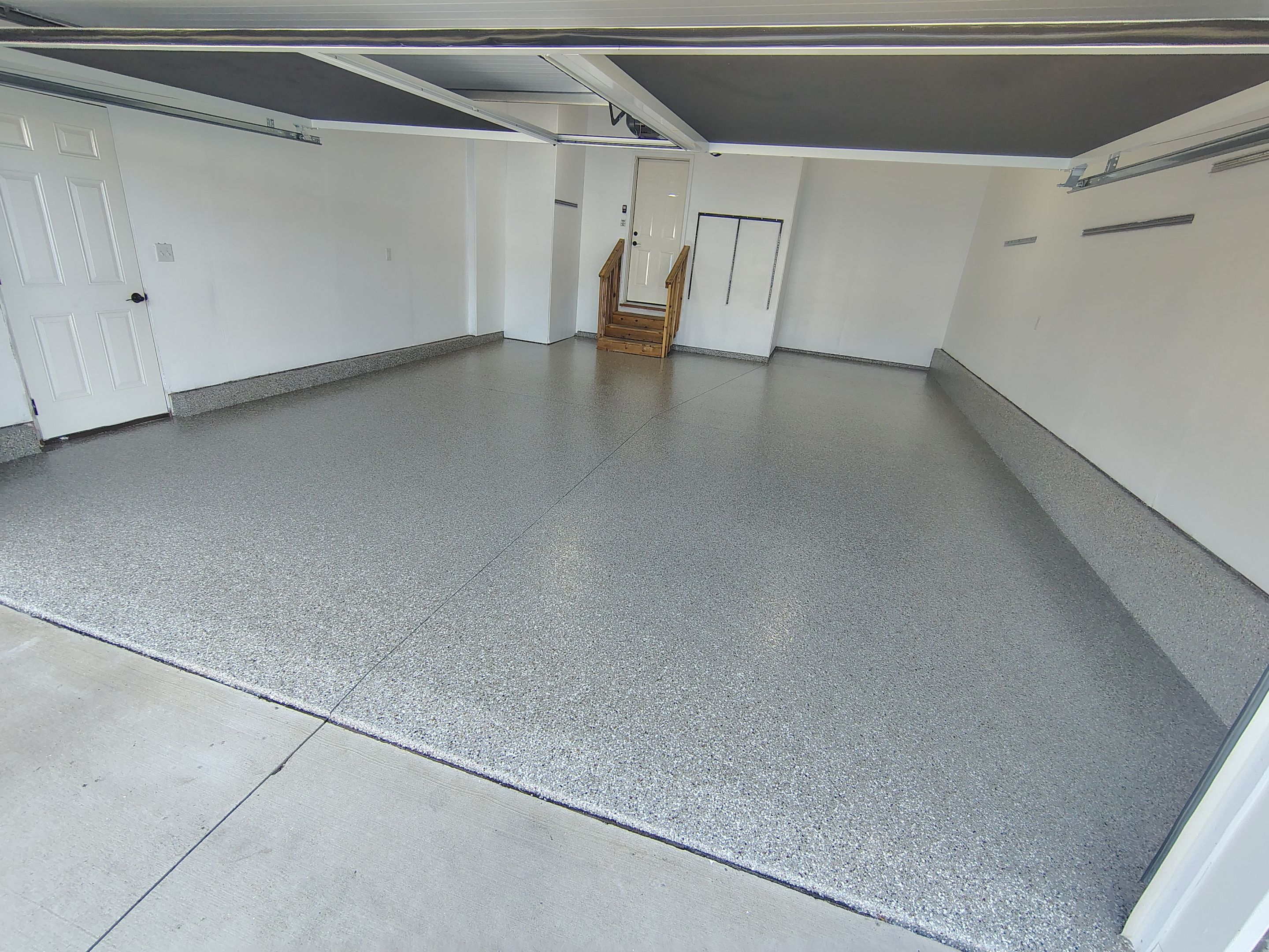 Sioux Falls Garage Floor Transformation With Gray Speckled Epoxy Coating by Select Painting, Coatings & Garage Cabinets