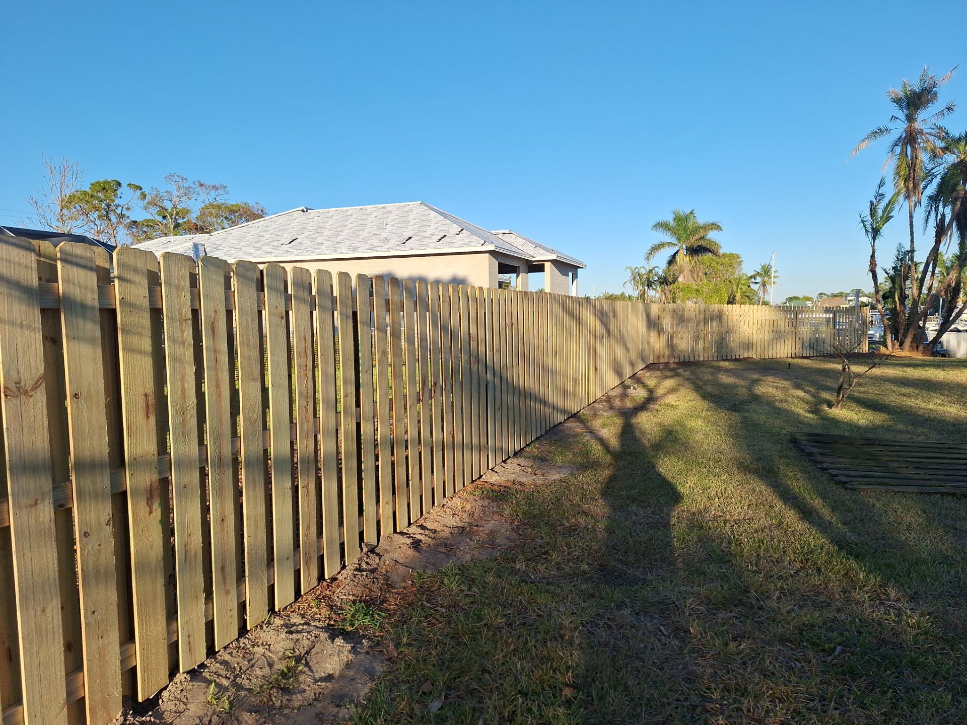 Wood Fence Installation using 6ft Pressure-Treated Wood Board-On-Board Privacy Fence with a 4Ft 3 Rail White Aluminum Fence by Asap fence and gates, LLC