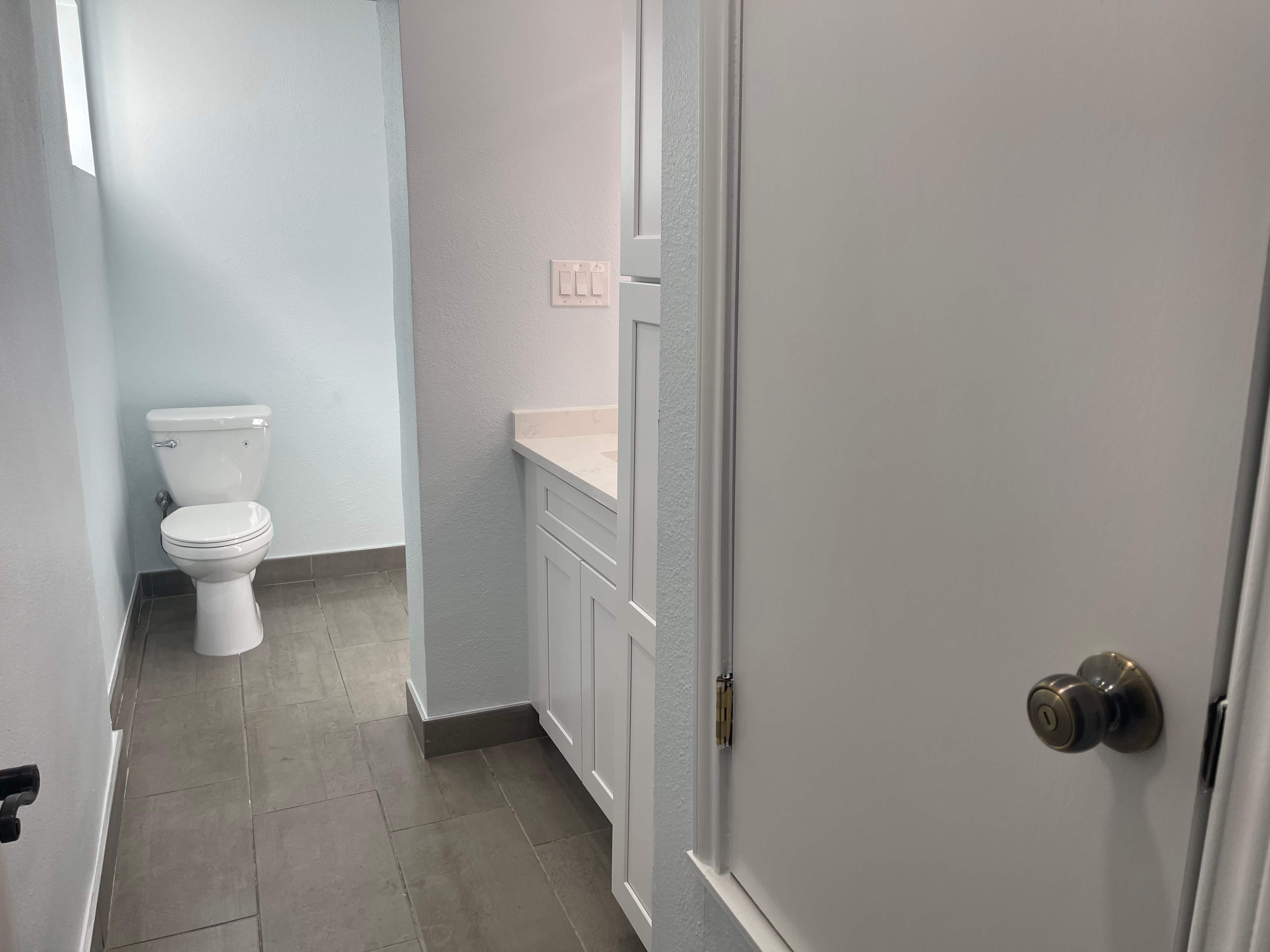 Complete Bathroom Remodel Featuring Marble Tile and Teal Herringbone Niche by Mena stone surfaces