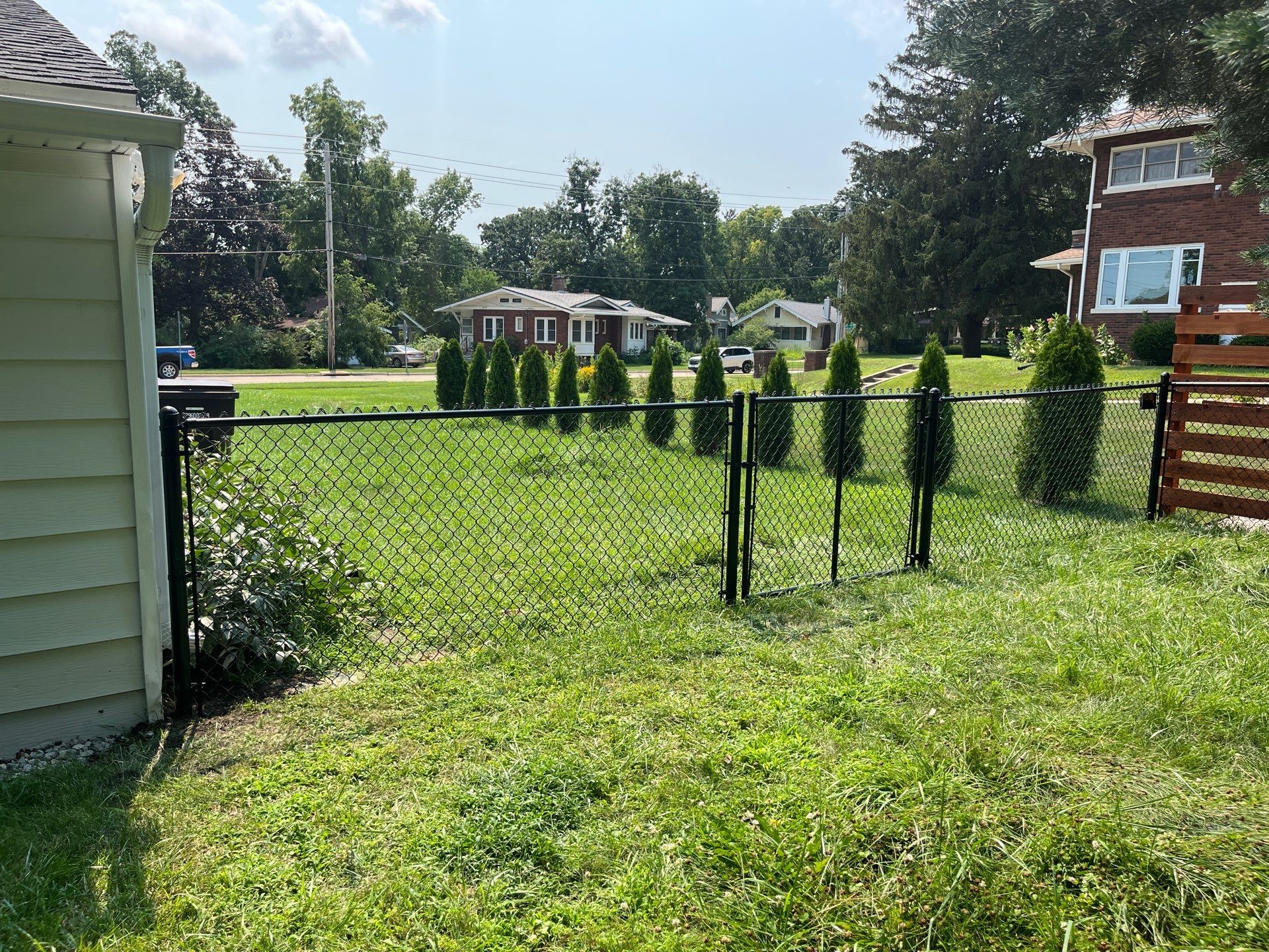 Residential Black Chain Link Fence Installation in Cedar Falls by Perfect Picket Fence and Stain