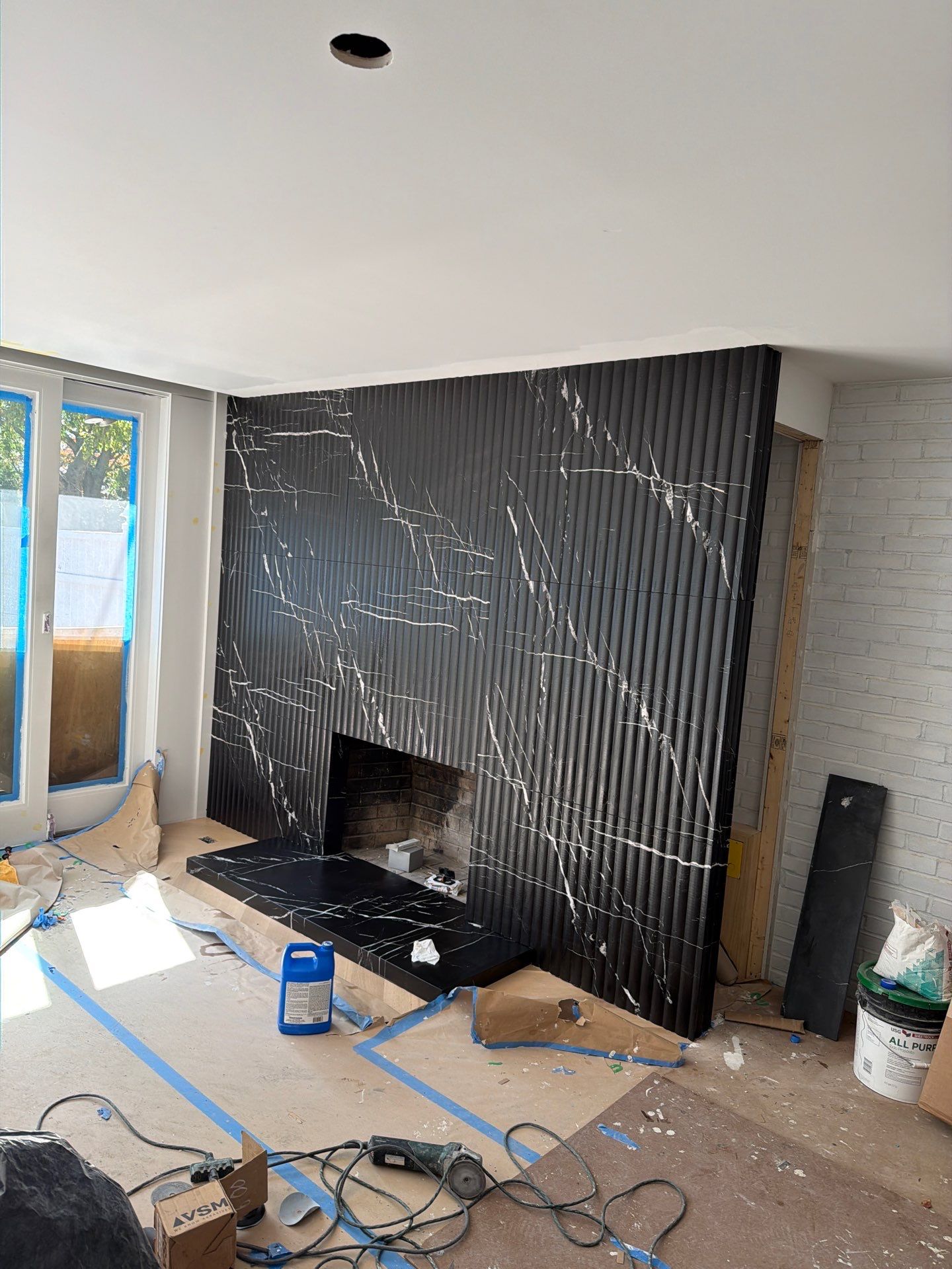 Full-Height Fluted Marble Fireplace Wall by NC Stone And Tiles