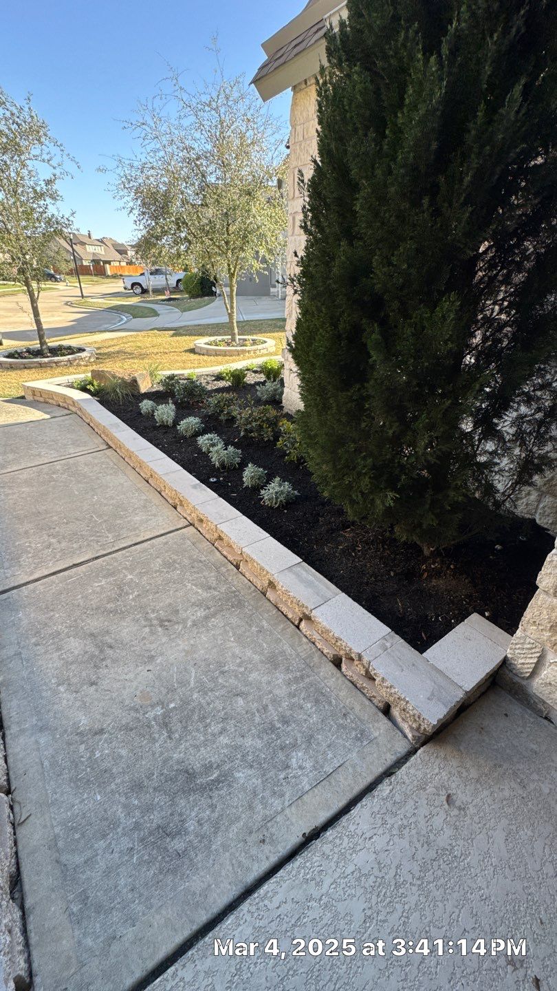 🌿✨ Darlene & Andrew’s Amazing Curb Appeal Transformation  Some projects are more than just landscaping—they’re a conversion of curb appeal from the ground up. For Darlene & Andrew, Alejandro and the Texas Urban Team designed and delivered a complete solution that reshaped their flower beds, solved drainage challenges, and gave new life to the sideyard.  💡 From planning to execution, every step was tailored to build both beauty and functionality:  🌸 Flower Beds, Reinvented  Demolition of old beds, plants, and mulch.  Fresh soil preparation, weed protection, and a brand-new retainer wall built with hand-cut stone and decorative caps.  Carefully selected plants and garden mix to ensure health and visual harmony.  💧 Drainage & Irrigation Upgrades  Outdated corrugated pipes replaced with PVC drainage lines to carry water safely away from the foundation.  New irrigation system combining drip lines and sprinklers—watering plants while keeping the house walls protected.  Sideyard drainage extended with catch basins and PVC piping to prevent water pooling and foundation stress.  🚶 Functional Sideyard with Walkway & Trash Area  Graded and leveled sideyard to manage runoff.  Installed a modern gravel and paver walkway for easy access.  Built a firm and tidy concrete-paver pad for trash containers—making the space both practical and polished.  🛠️ Stonework & Craftsmanship  Every stone in the retainer wall was cut, set, and secured by the team of handcrafters, ensuring a durable build that doubles as a design statement.  ✅ Outcome: Darlene & Andrew’s property now has better drainage, a clean and organized sideyard, and elegant new flower beds—all designed for long-term durability and lasting beauty.  📢 Before hiring anyone, review our portfolio. Our work speaks louder than words—each project is a blend of function, protection, and design crafted to last. by Texas Urban Elements