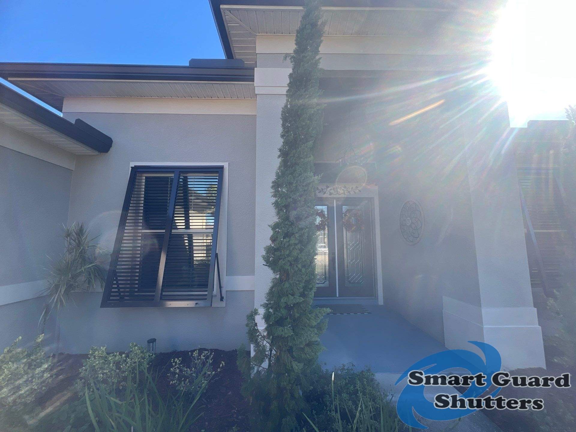 Impact Bahama Shutters in Grey Brown by Smart Guard Shutters