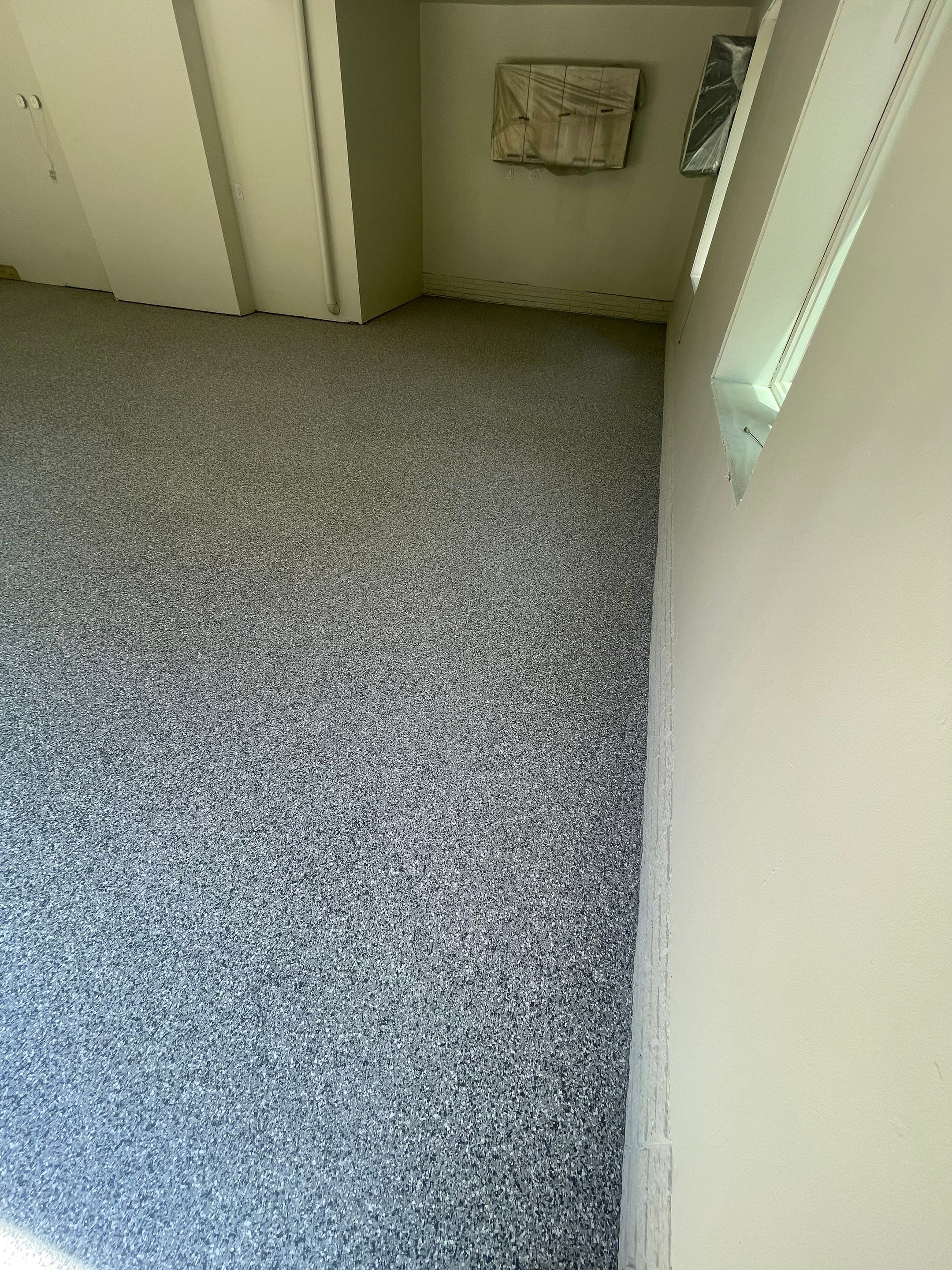 Gray Speckled Epoxy Garage Floor Coating in Sioux Falls by Select Painting, Coatings & Garage Cabinets