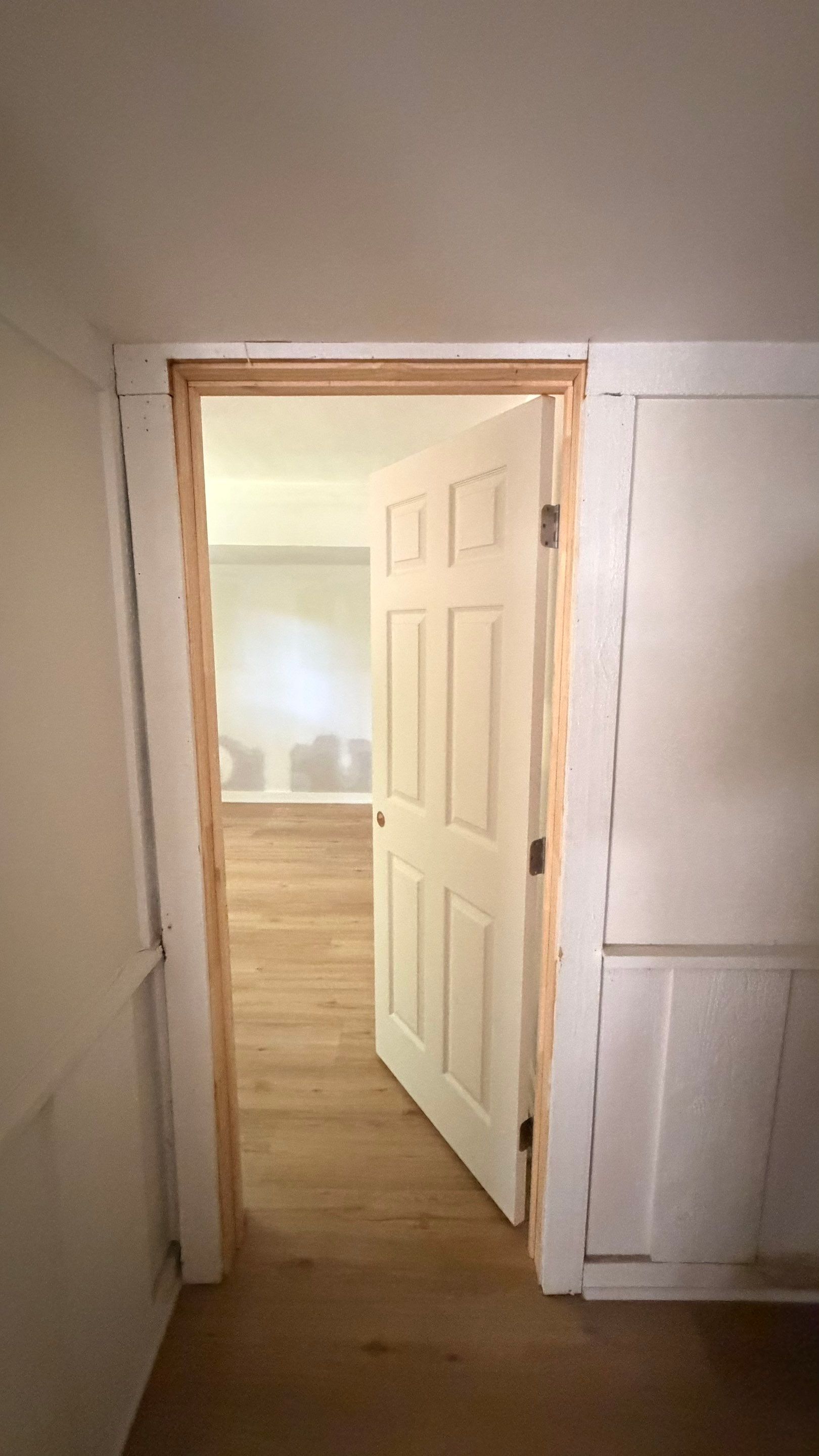 Basement Remodeling with Wood-Look Flooring and Custom Wainscoting in Dunwoody by Swift Home Renovations