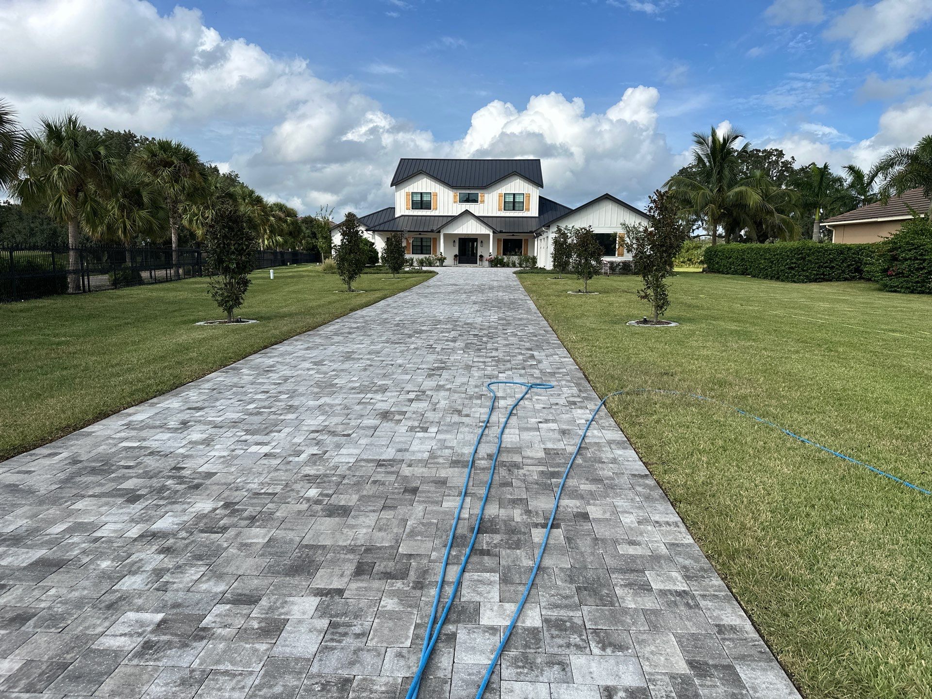 Complete Two-Story House Wash and Driveway Cleaning in Winding River Community, Bradenton, FL by Sunshine AquaWash