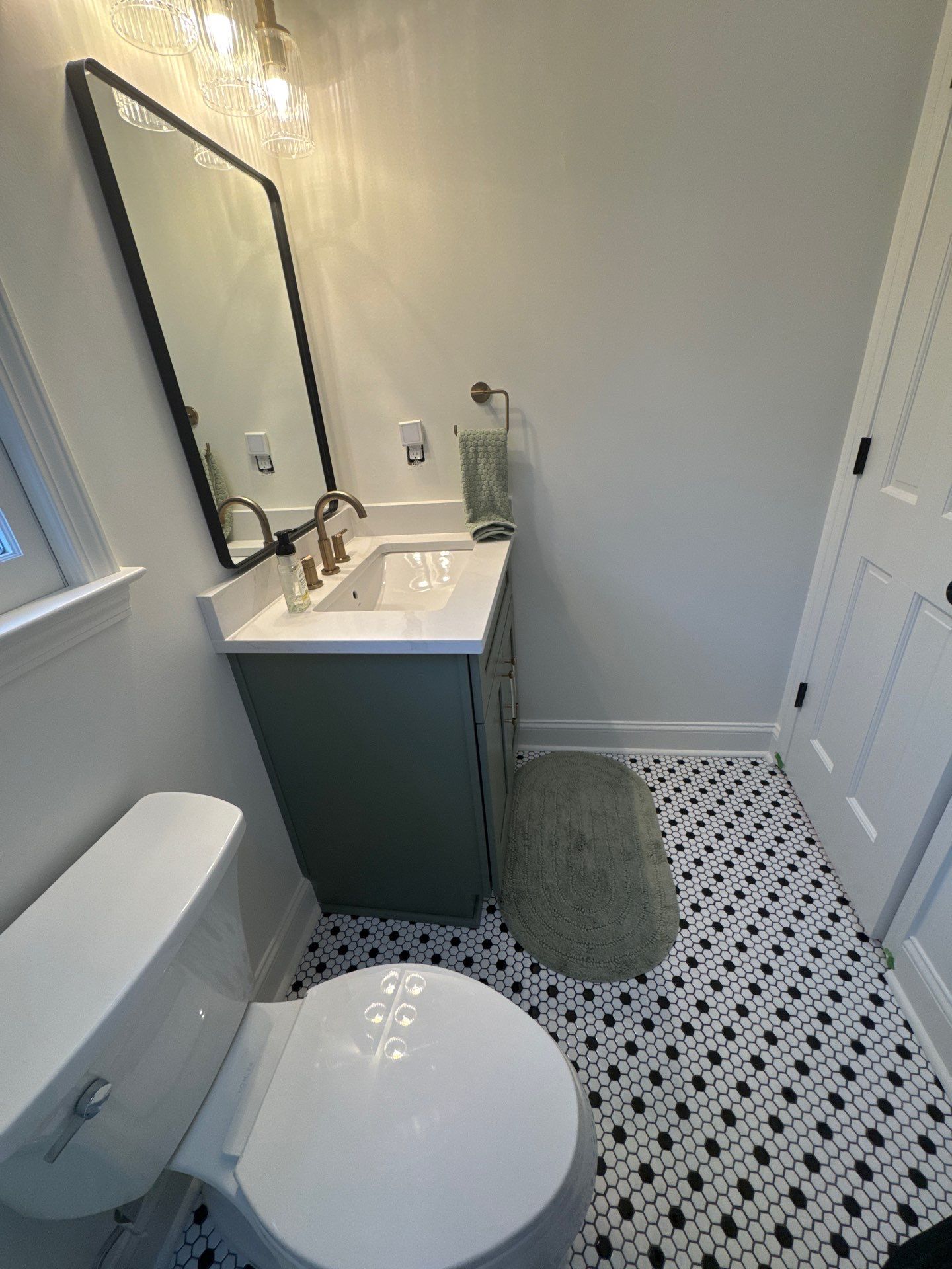 Smyrna Bathroom Remodel Featuring Sage Green Vanity and Hexagonal Tile by Swift Home Renovations