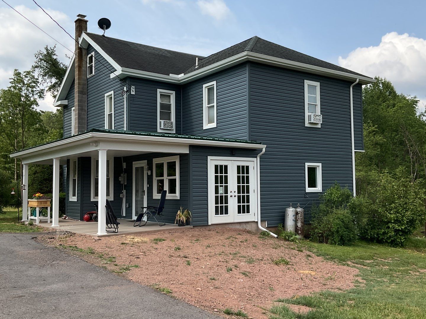 Porch roof [green] and new siding by Esh Builders