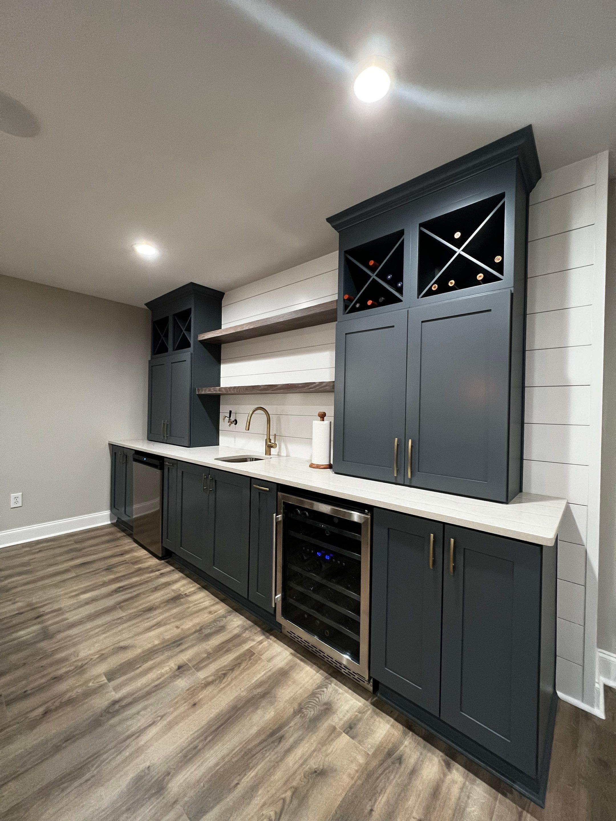 Modern Basement Remodeling in Woodstock with Custom Live-Edge Bar by Swift Home Renovations