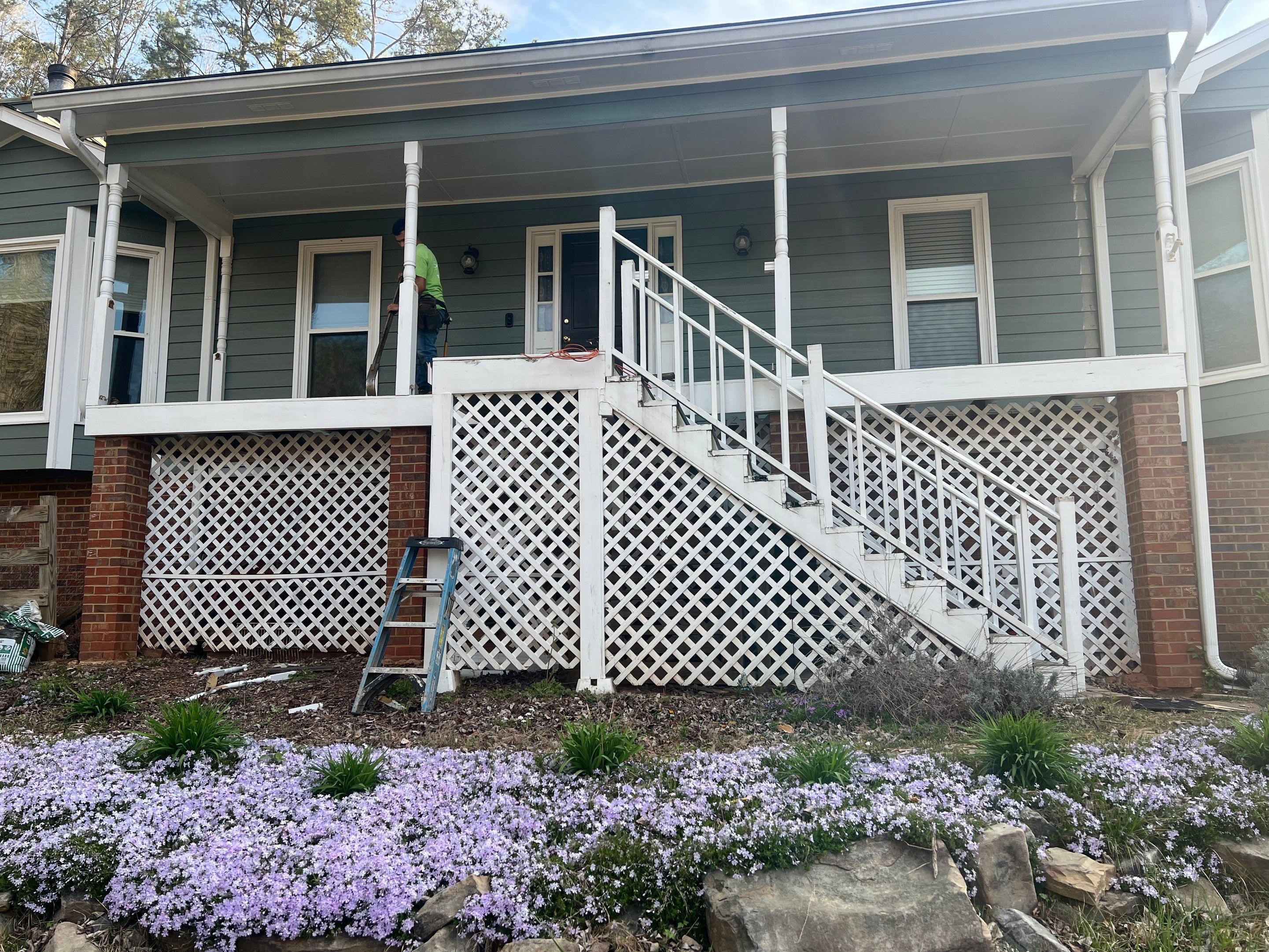 Composite Deck and Porch Renovation With Black Metal Railings by Swift Home Renovations 
