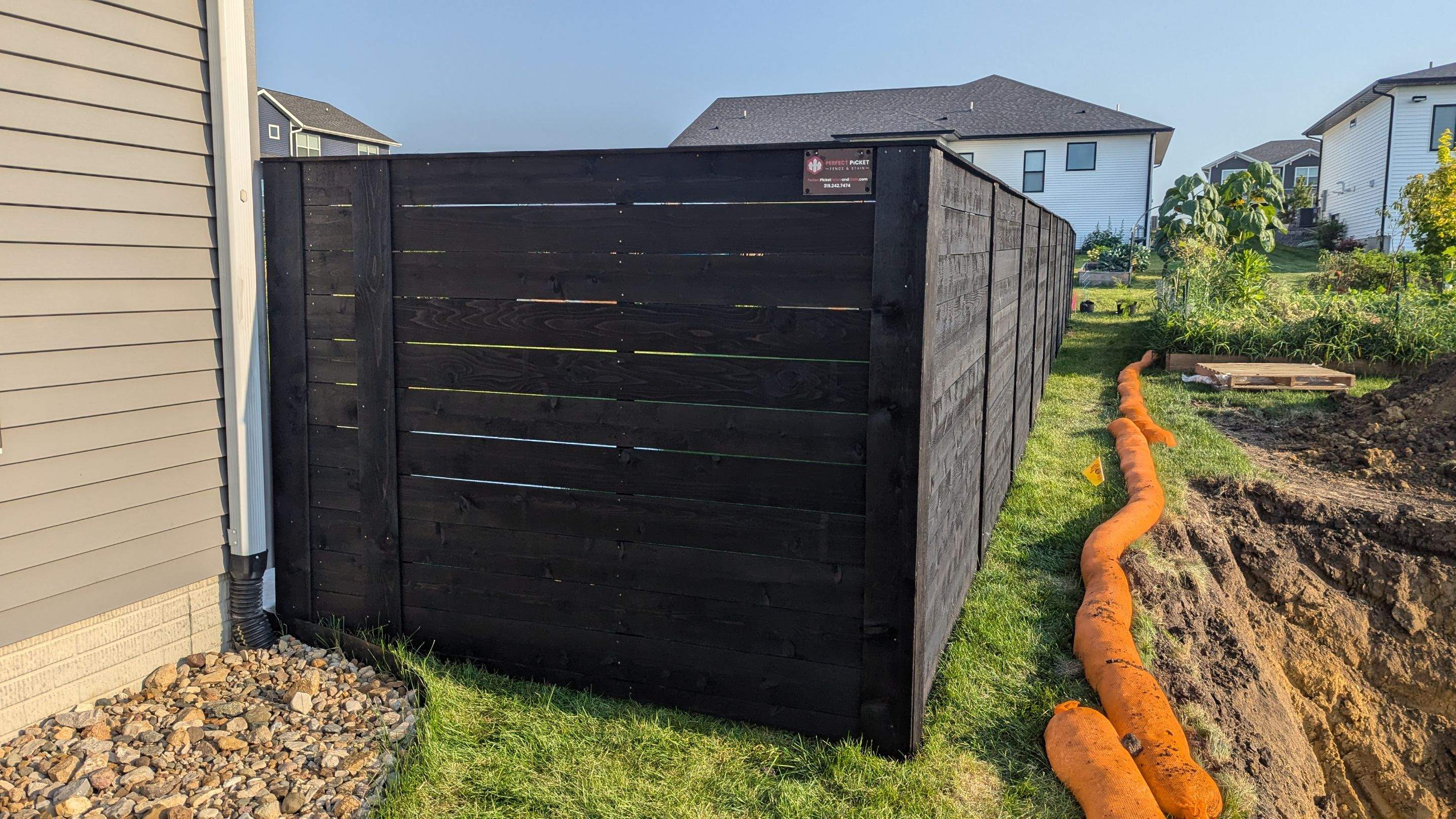 Modern Black Stained Horizontal Privacy Fence Installation in Cedar by Perfect Picket Fence and Stain