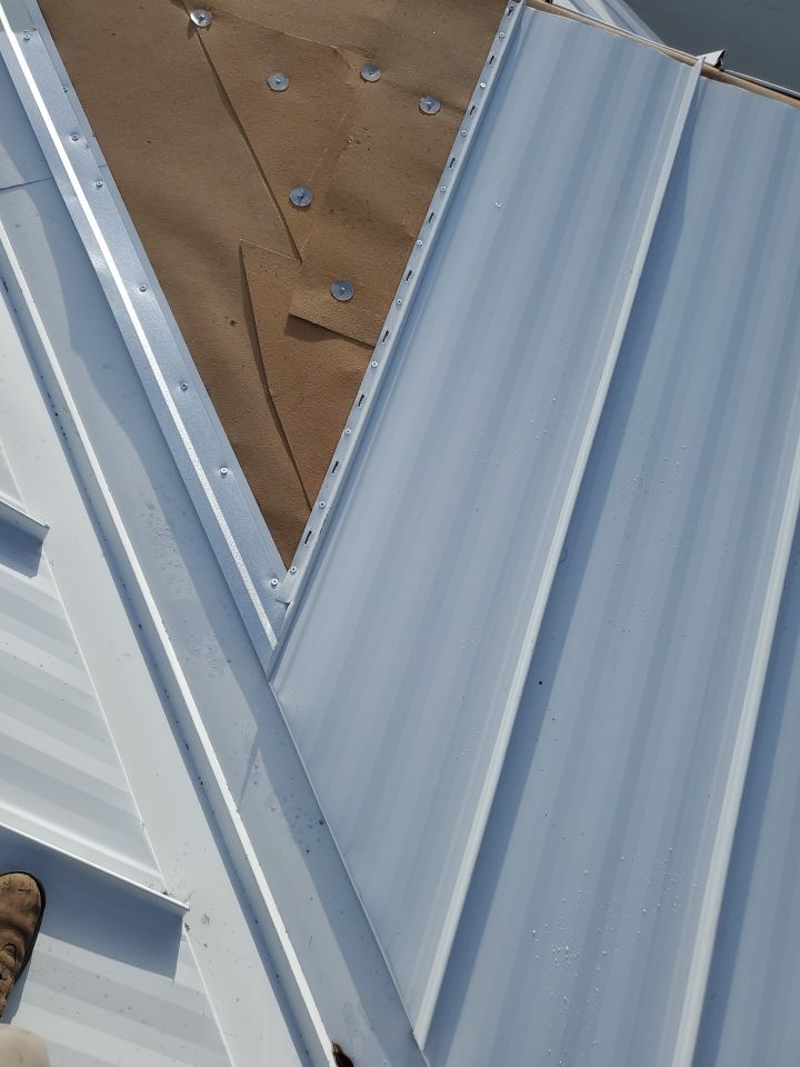 Residential Roofing Installation using 1.5" Nail Strip 24ga Solar White Kynar Coated Standing Seam Metal Panels by Morton Roofing, Inc.