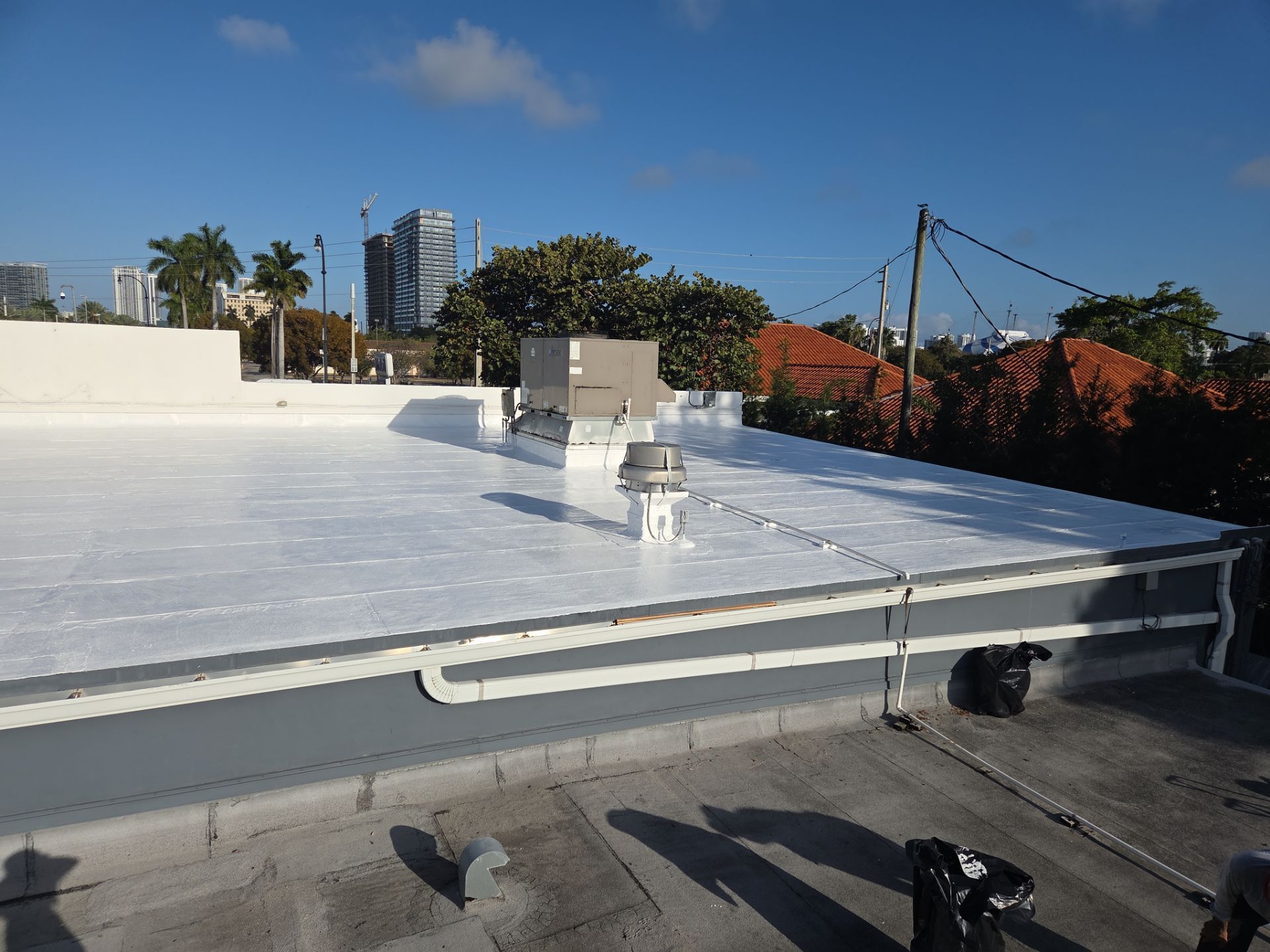 Commercial Flat Roof Restoration Using Silicone Coating in Hallandale Beach by Aastro Roofing