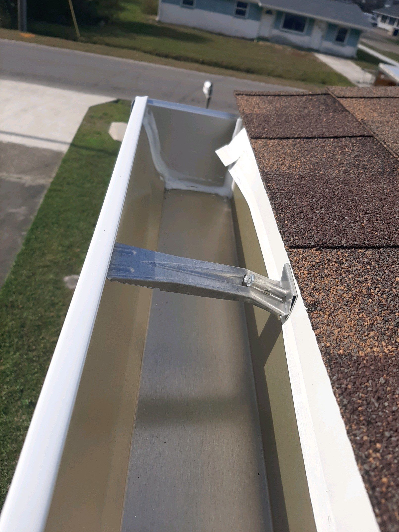 Gutter Installation using White Seamless Gutters by Gutter Professors
