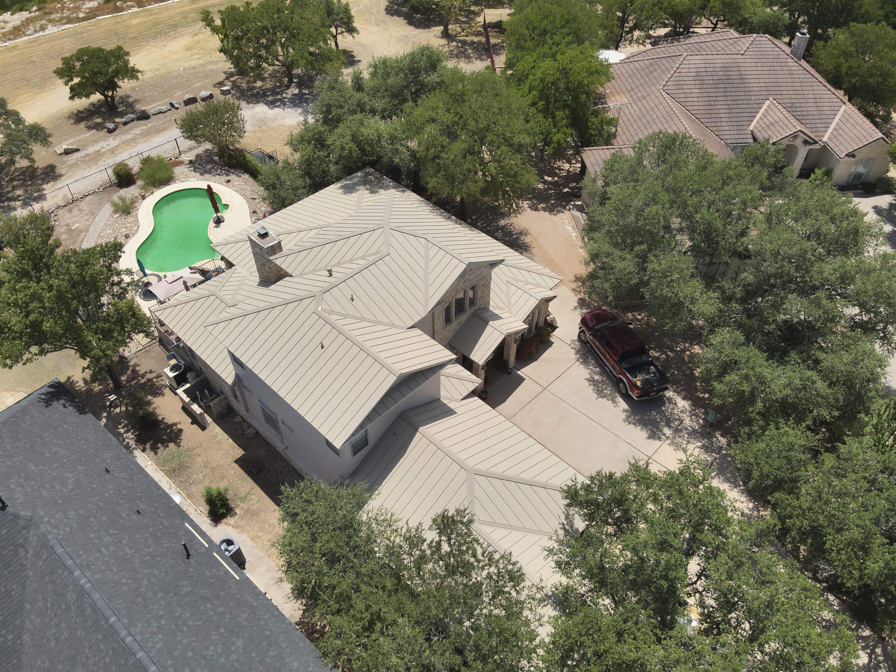 Residential Roof Replacement using 24 GA Double-Lock - Surrey Beige by Action Exteriors Austin