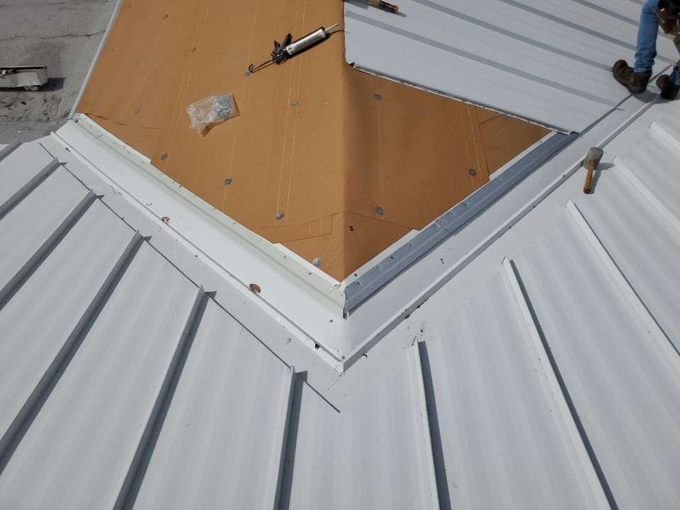 Residential Roofing Installation using 1.5" Nail Strip 24ga Solar White Kynar Coated Standing Seam Metal Panels by Morton Roofing, Inc.