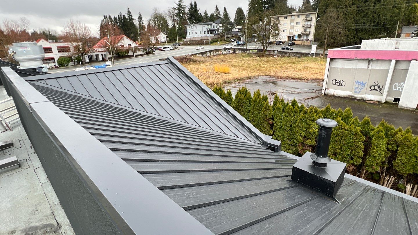 Commercial Roofing Installation using 12" Prolok metal and hidden gutters! by Top Notch Roofing Inc