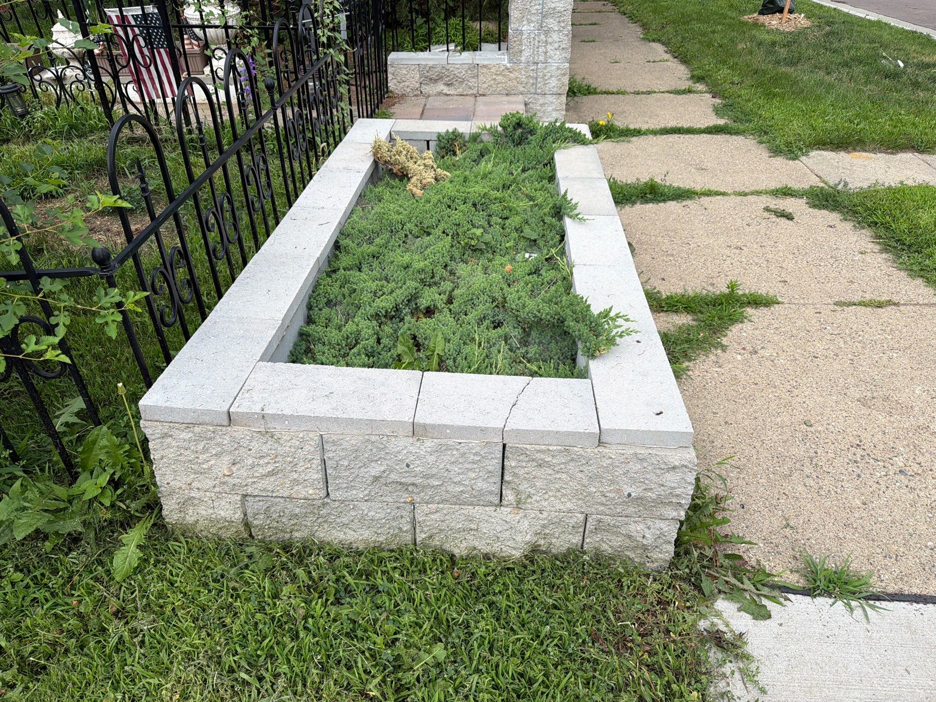 Exterior Masonry Painting for a Sioux Falls Retaining Wall by Select Painting, Coatings & Garage Cabinets