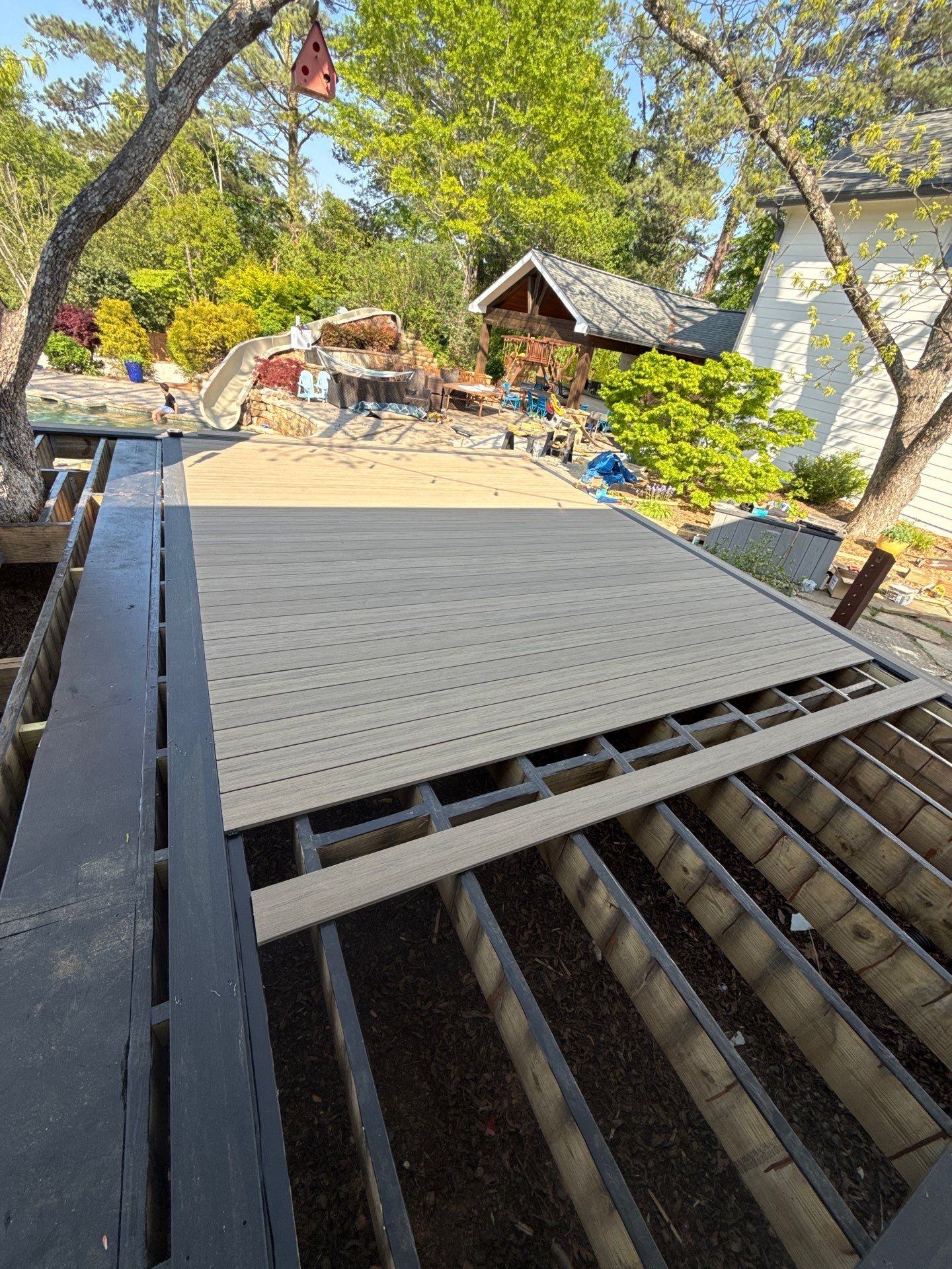 Deck Resurface with Glass Paneling and Deckorators Voyage Series Products by Nelson Exteriors 