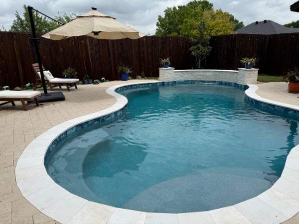 Resort-Style Freeform Pool with Travertine Decking by Pinnacle Pools and Spas - DFW