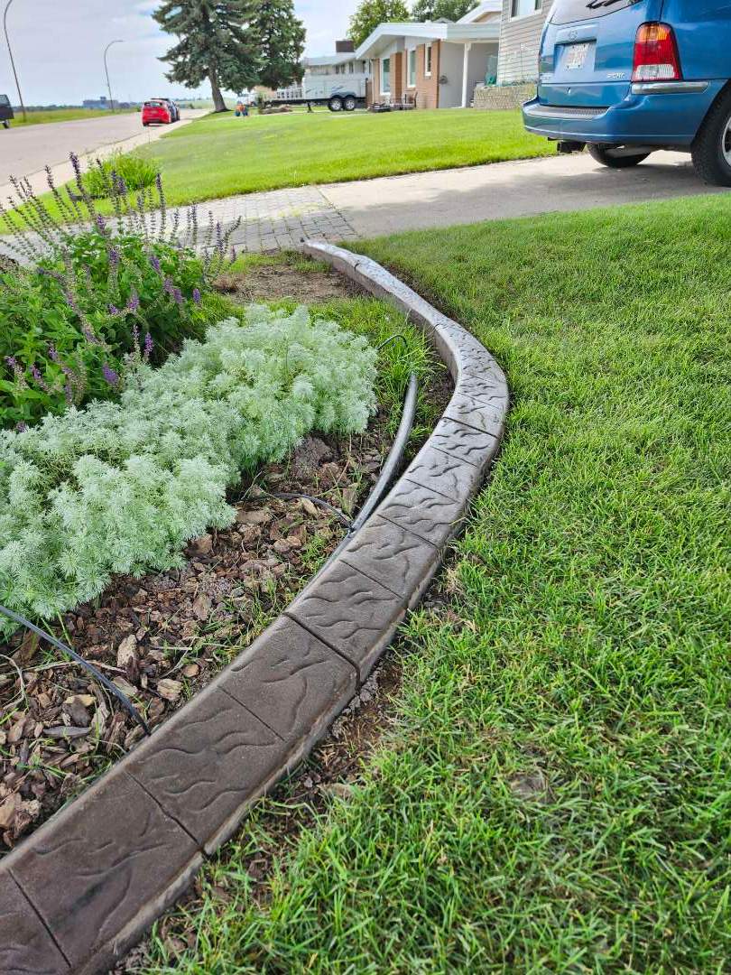 Decorative Stamped Concrete Landscape Edging Installation in Medicine Hat by Pump it Up Concrete Jacking