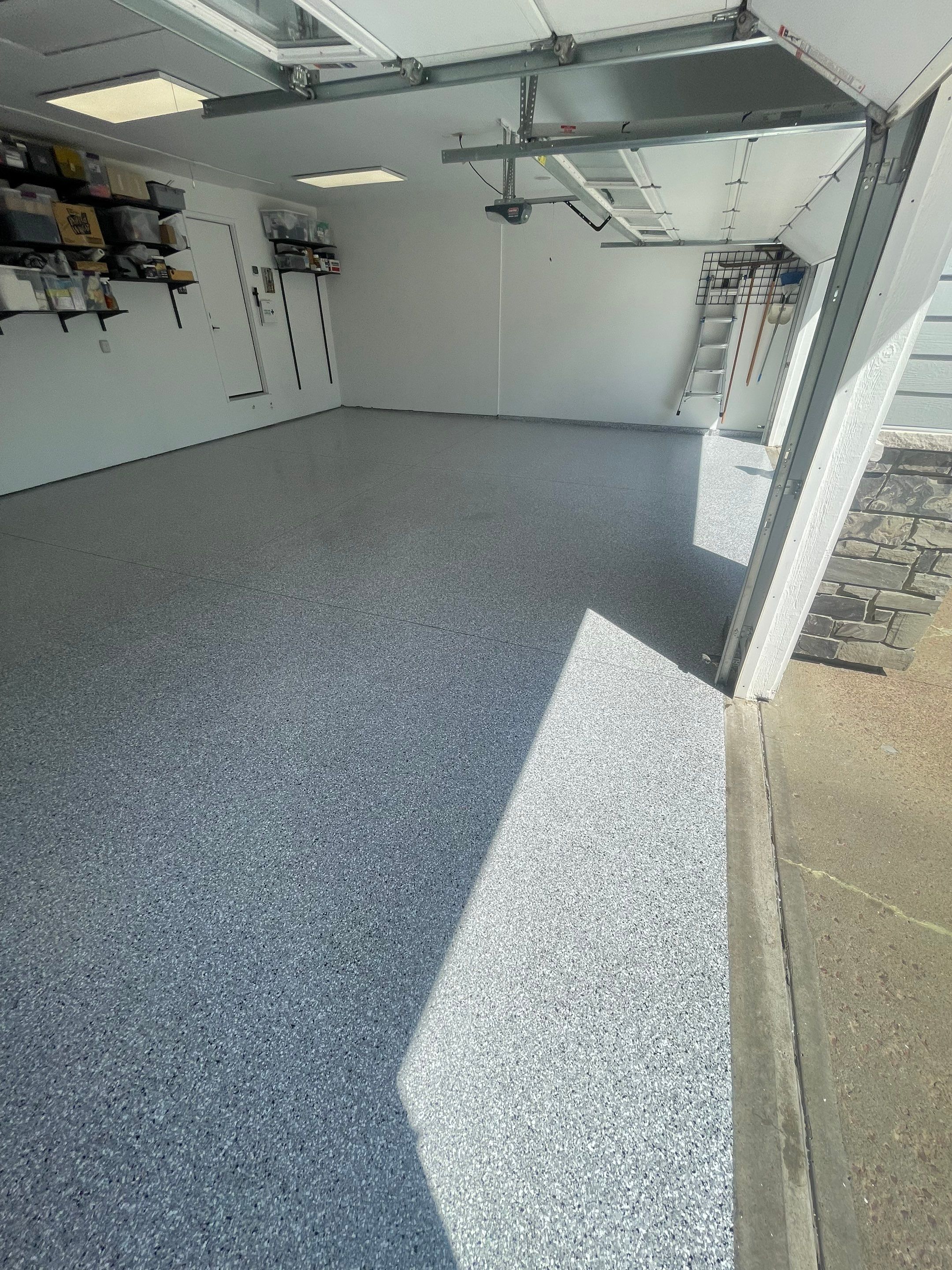 Feather Grey Garage Floor Coating Installation in Sioux Falls by Select Painting, Coatings & Garage Cabinets
