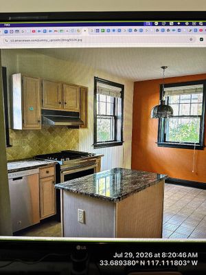 Modern Kitchen Renovation Featuring Dual-Tone Cabinetry and Granite in Lincoln