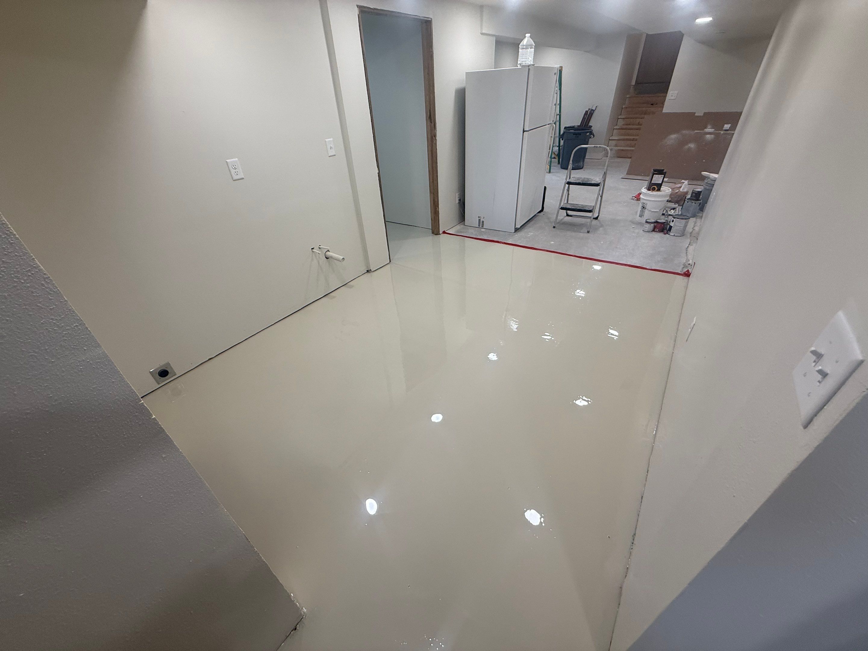 High-Gloss Epoxy Floor Coating and Basement Renovation in Rock Rapids by Select Painting, Coatings & Garage Cabinets