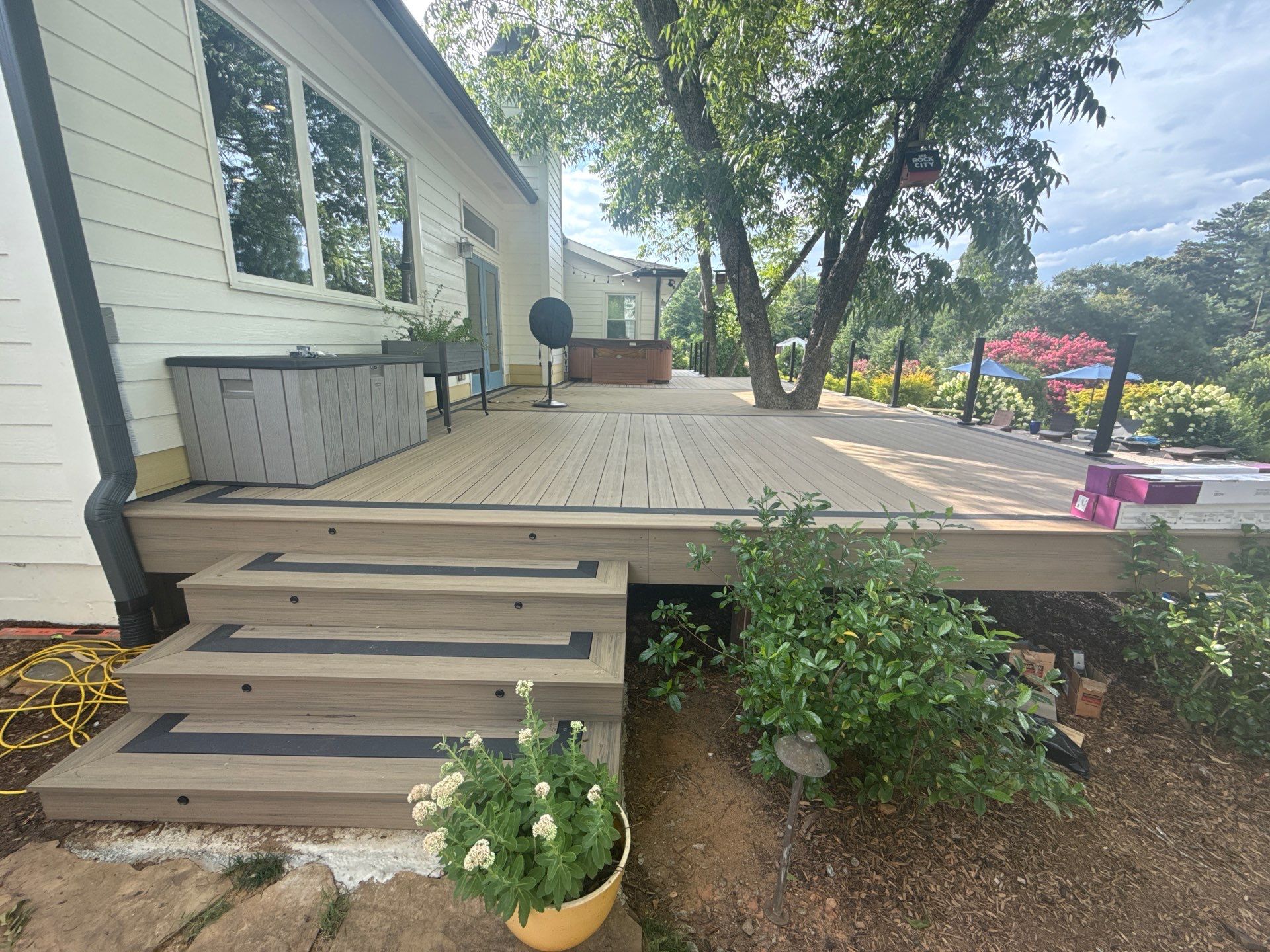 Deck Resurface with Glass Paneling and Deckorators Voyage Series Products by Nelson Exteriors 