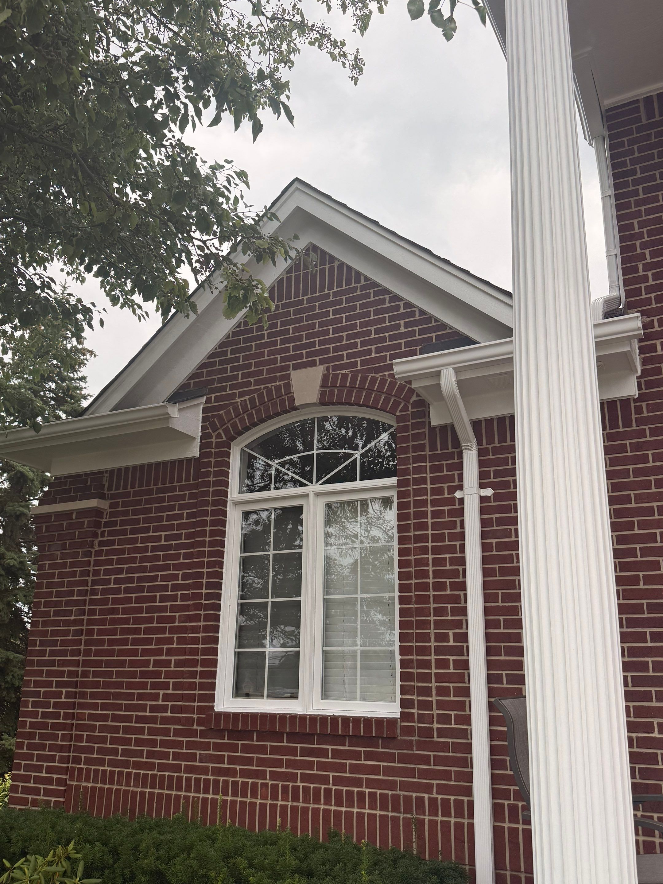 Siding and Trim Repair and Exterior Painting for a Macomb Brick Residence by Top Shelf Painter